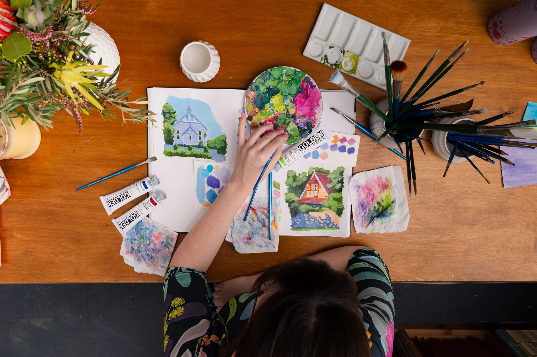 Brisbane artist captured mid-process creating vibrant nature-inspired artwork