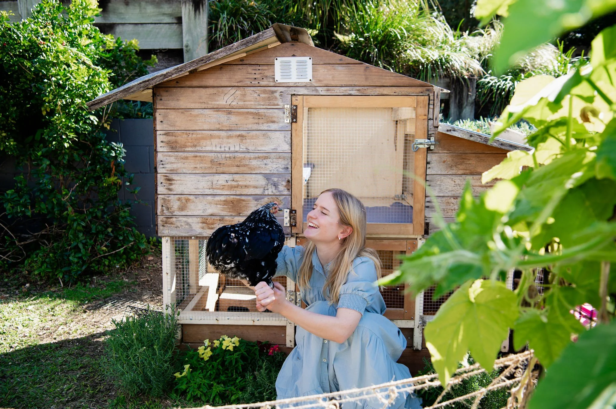 Artist Ingrid Bartkowiak in her veggie garden with chickens