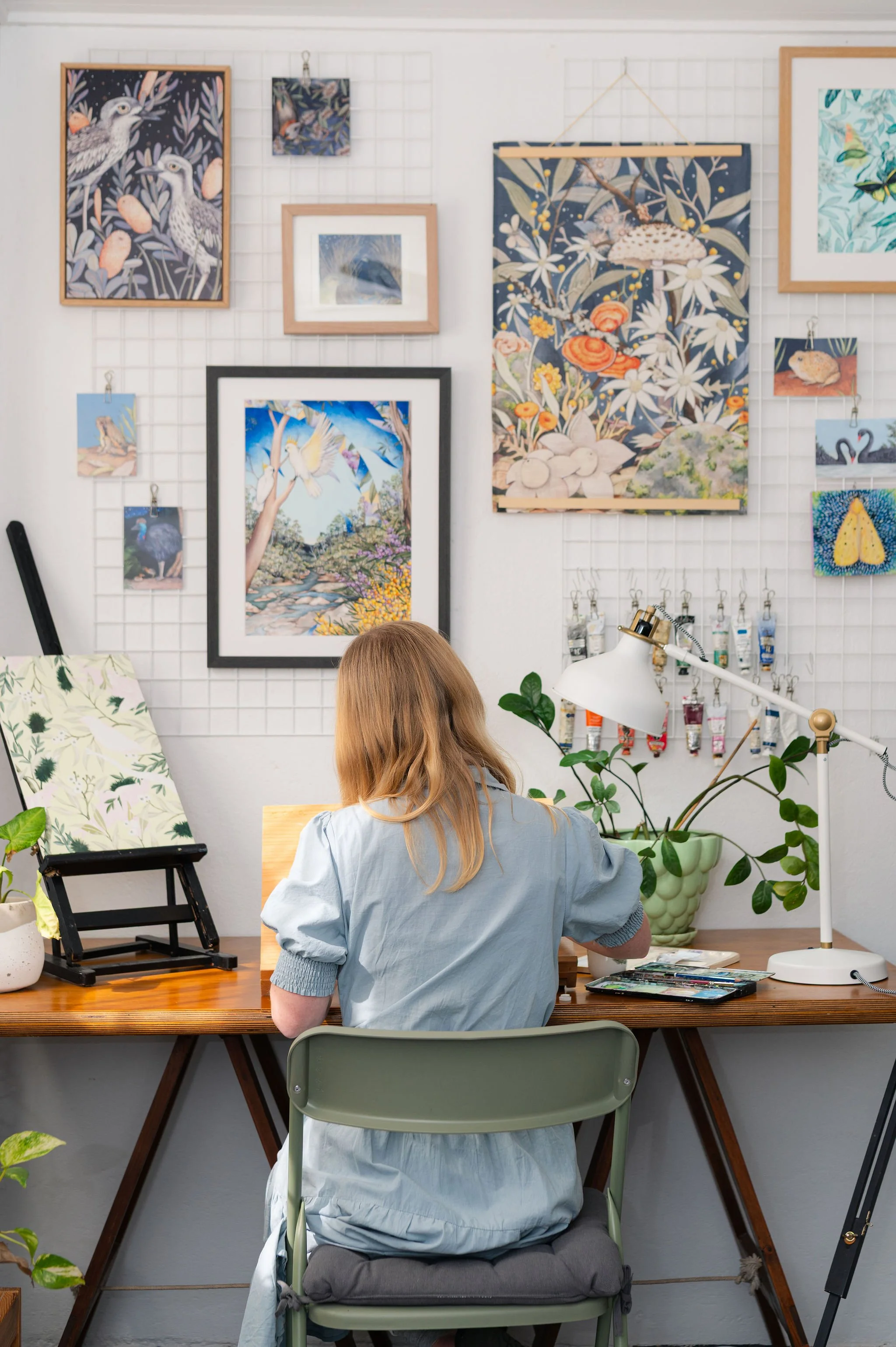 Ingrid Bartkowiak in her studio surrounded by colourful artwork