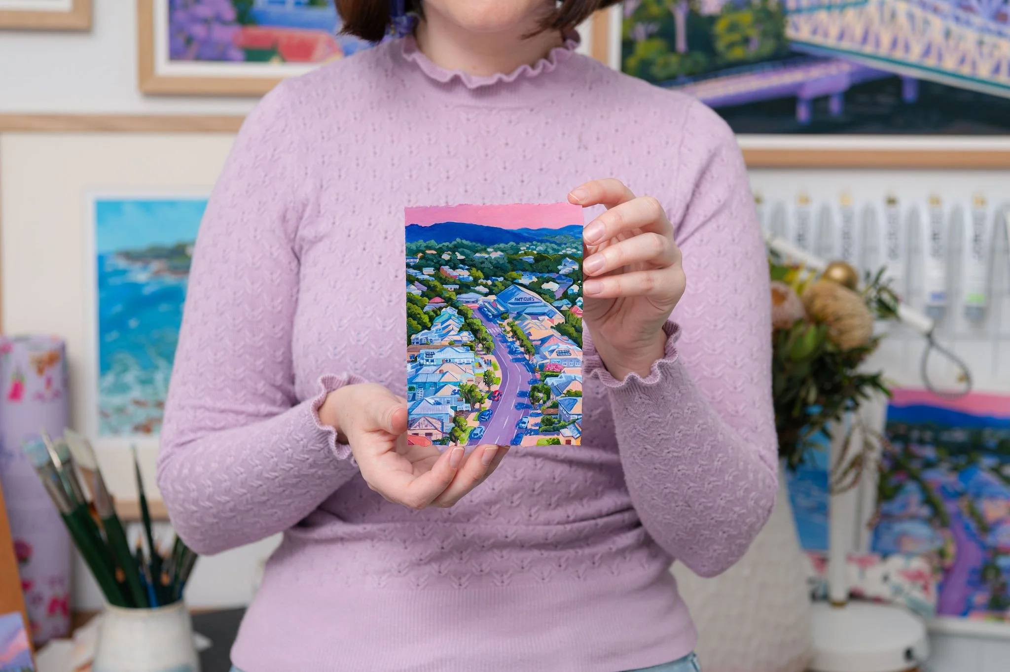 Brisbane artist Eliza painting in her studio