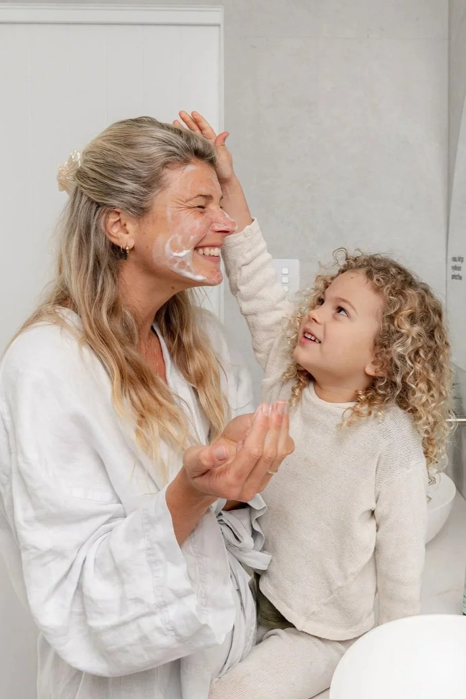 Mum and toddler playing together during a lifestyle skincare photoshoot at home
