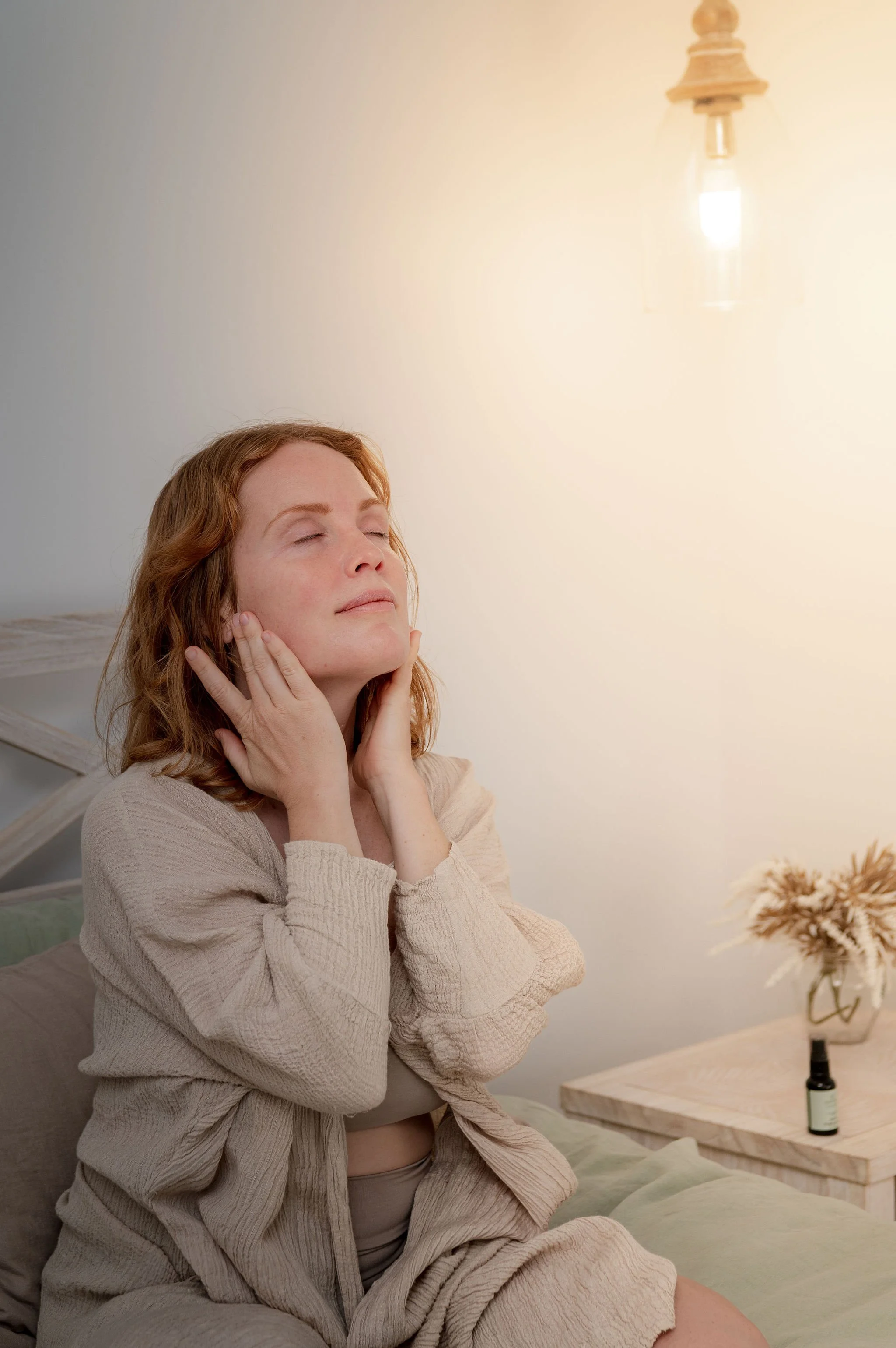 Mother applying Sanctum skincare product during quiet self-care moment