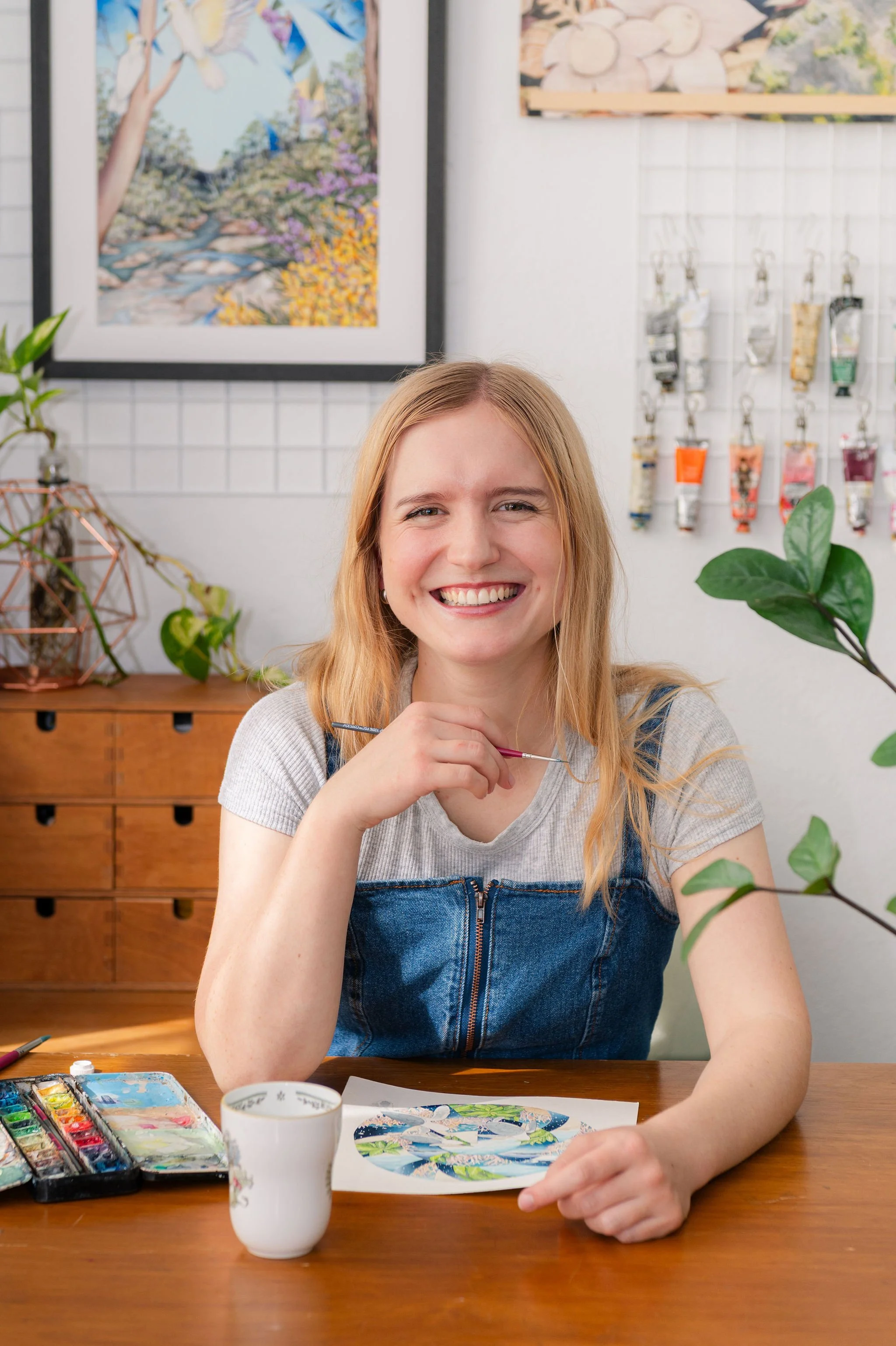 Portrait of Brisbane artist Ingrid Bartkowiak in her studio surrounded by colourful artwork