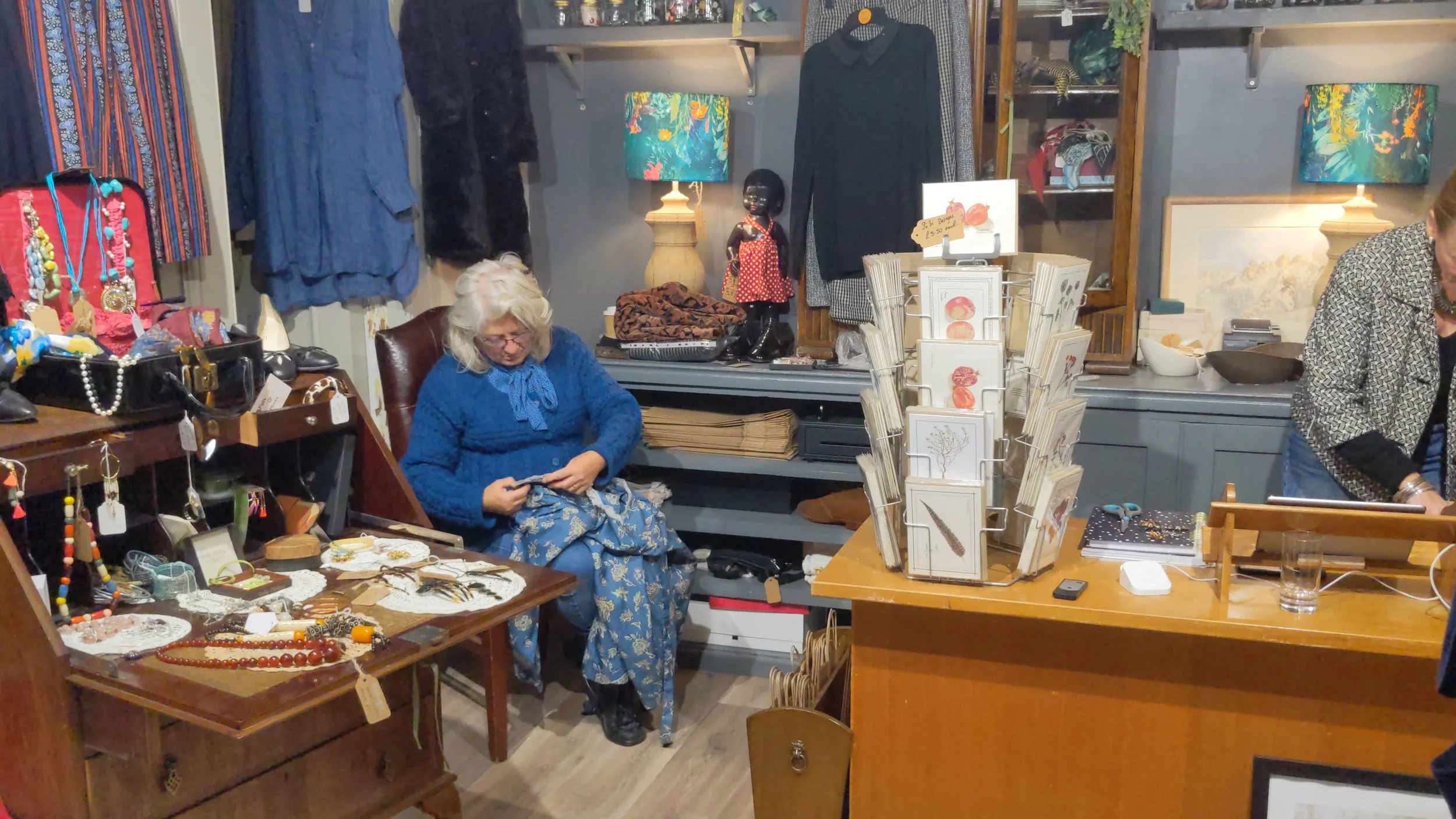 A volunteer mending clothes inside Hope & Glory on Post House Wynd, Darlington town centre.