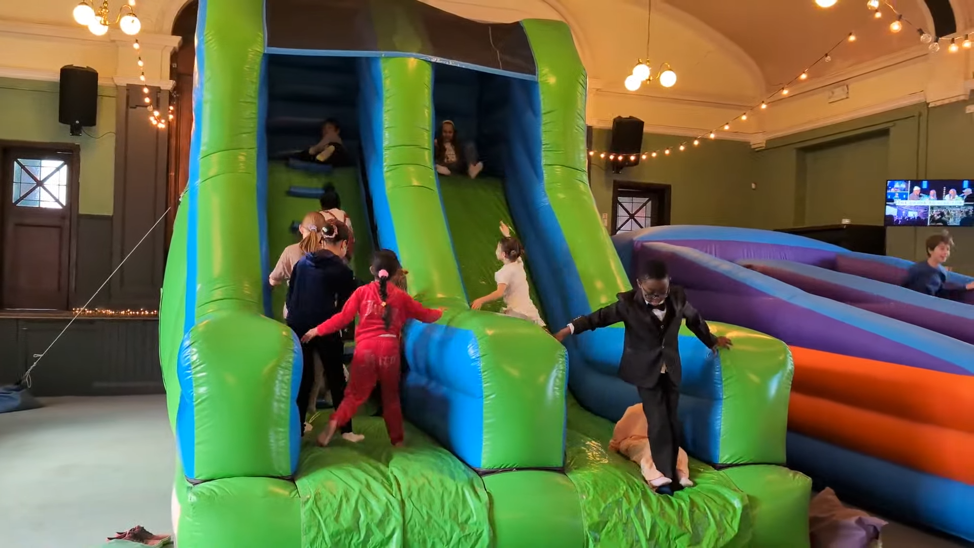 Young people including children and youth playing on an inflatable slide at Darlington Vineyard Church, Salt Yard.