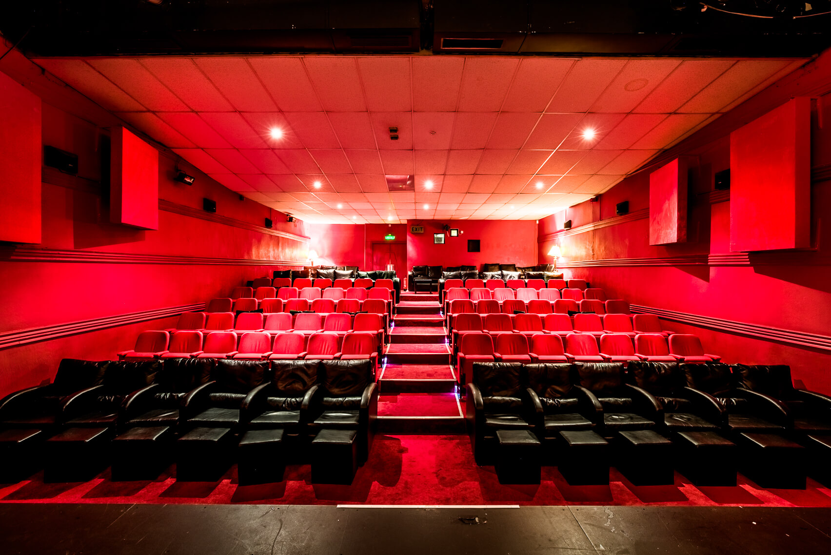 electric-cinema-profile-shot-from-stage-into-audience-interior-empty-red-seats-backlight-consulting.jpg