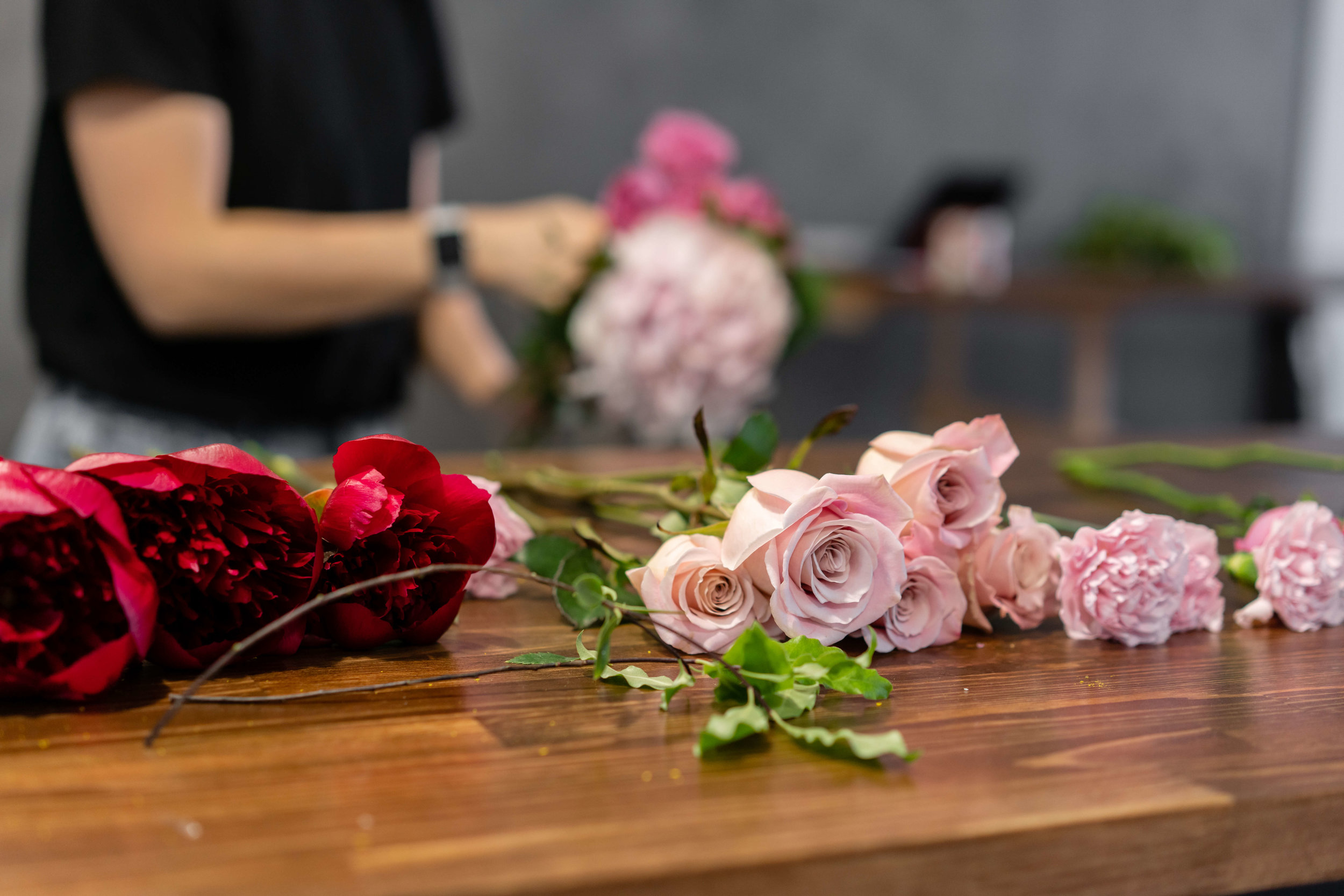 Roses, carnations and peonies laid out for a workshop