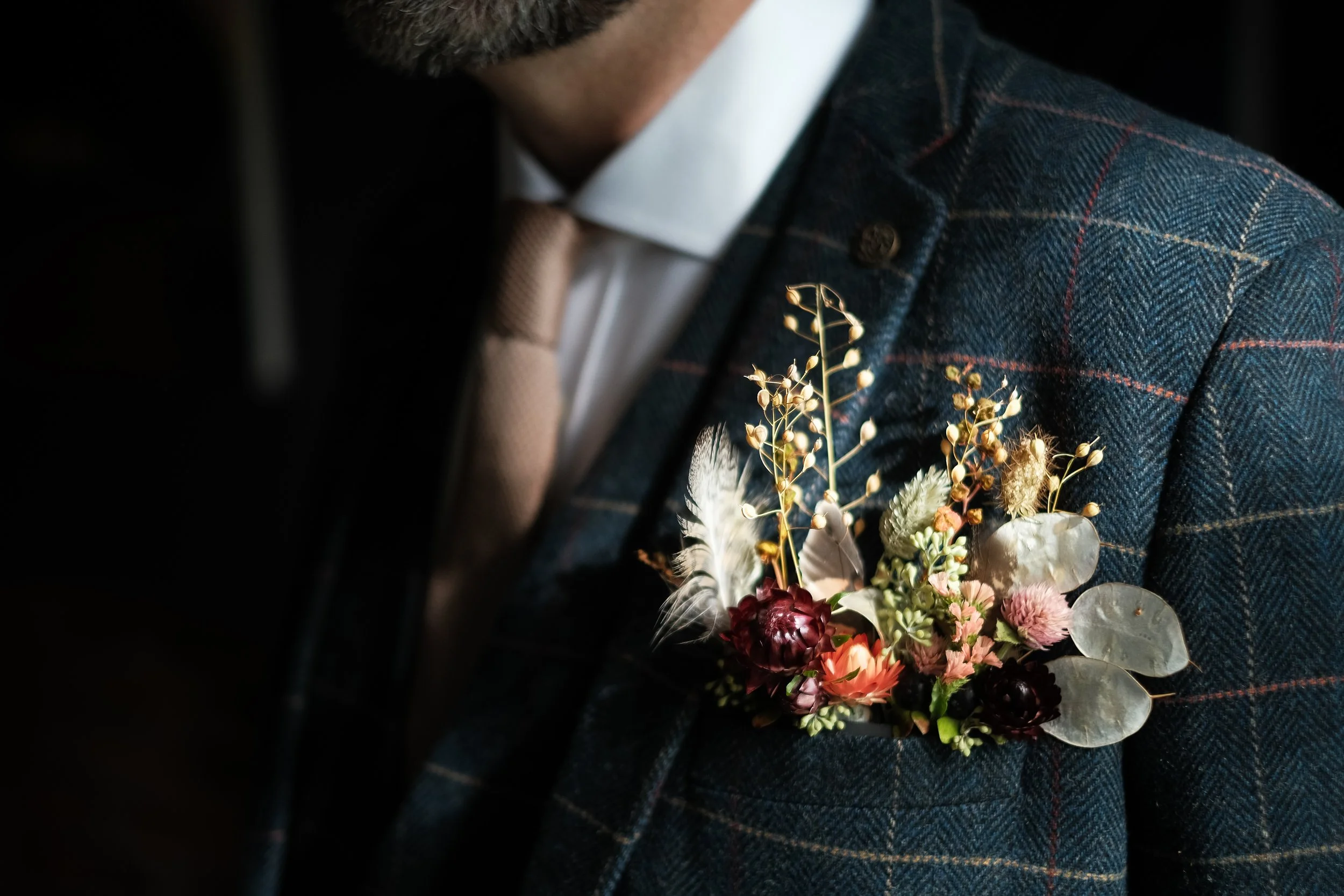 A groom's pocket meadow in autumnal colours and including dried flowers.