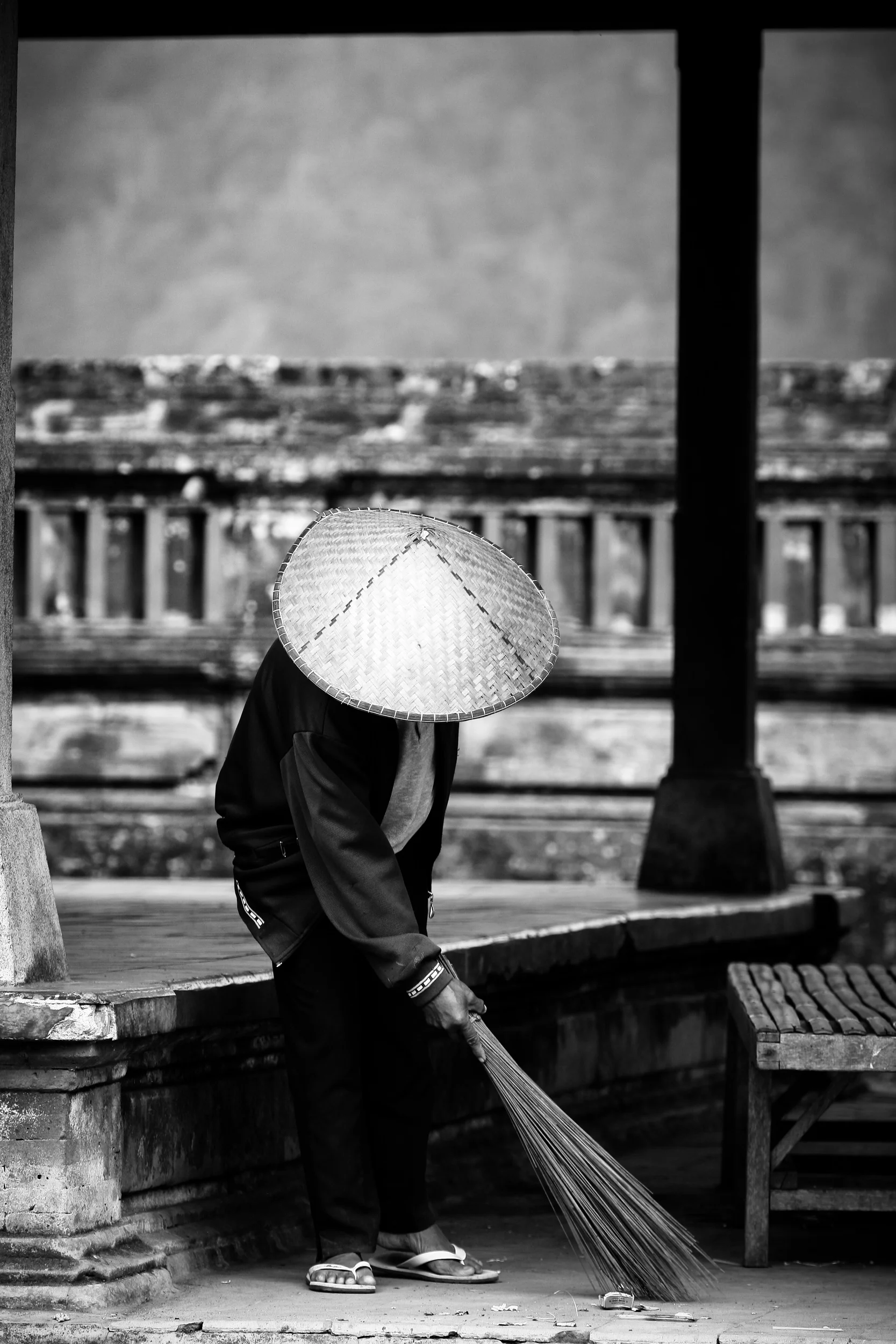 Old man working in the temple, Bali, Indonesia