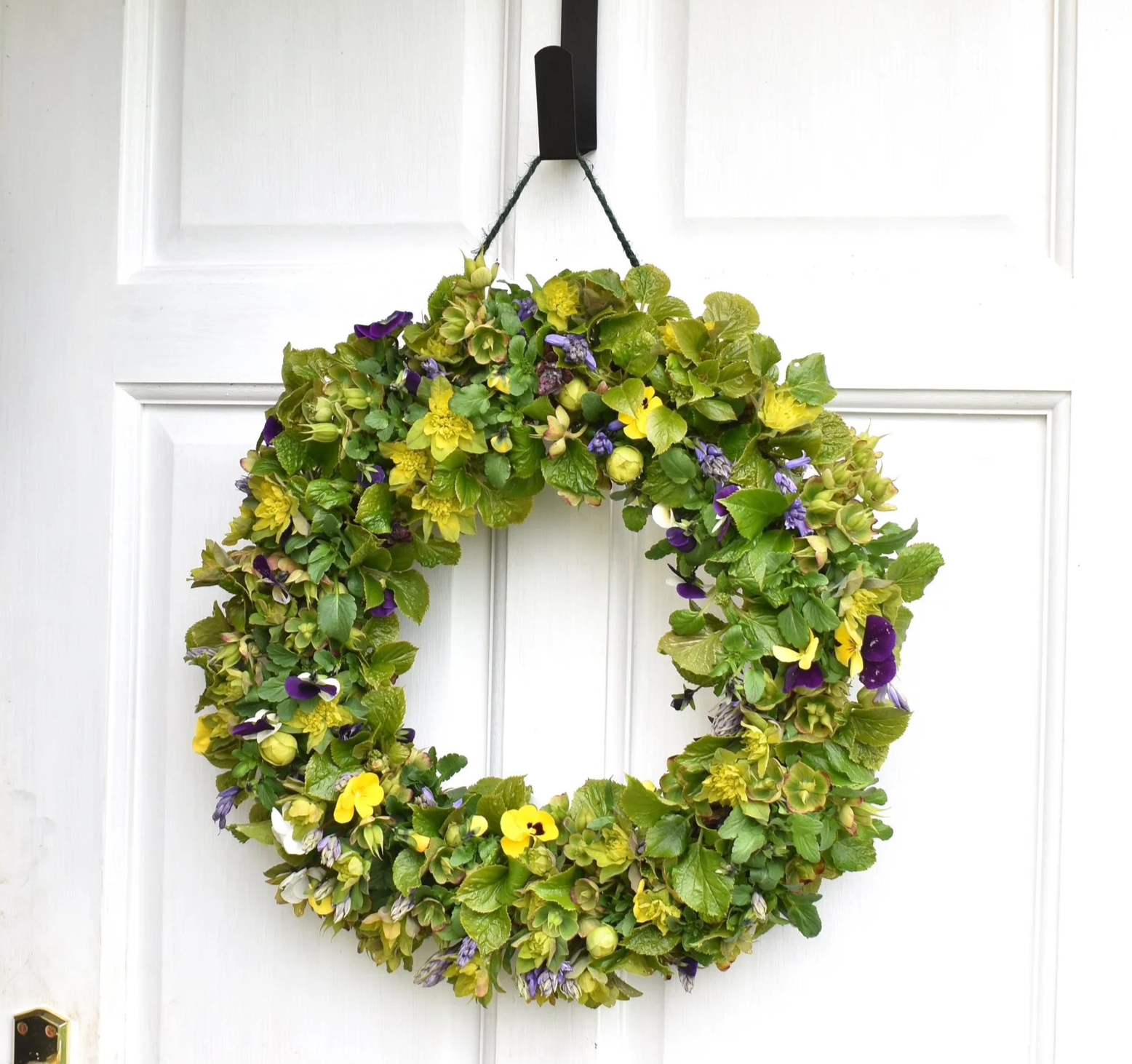 Spring wreath on open door.png