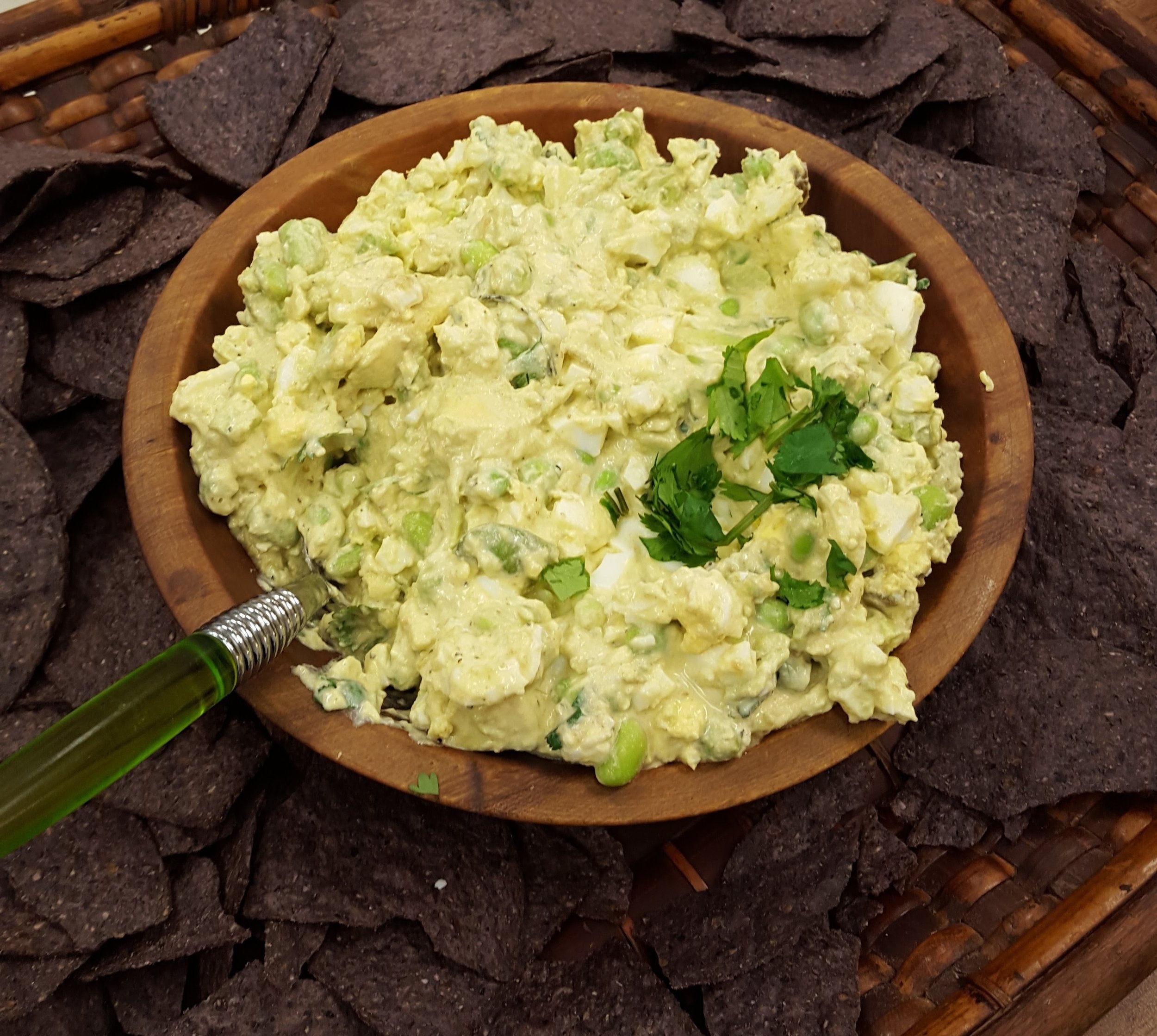 Egg Salad Guacamole with Edamame served with blue corn chips.