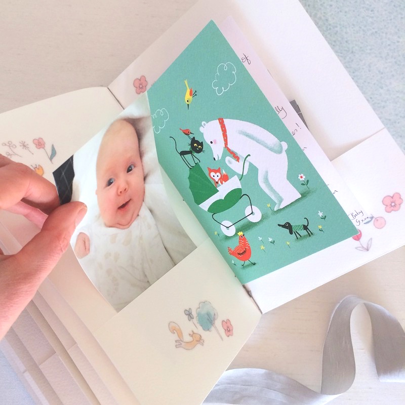 Pockets for mementos in baby record book