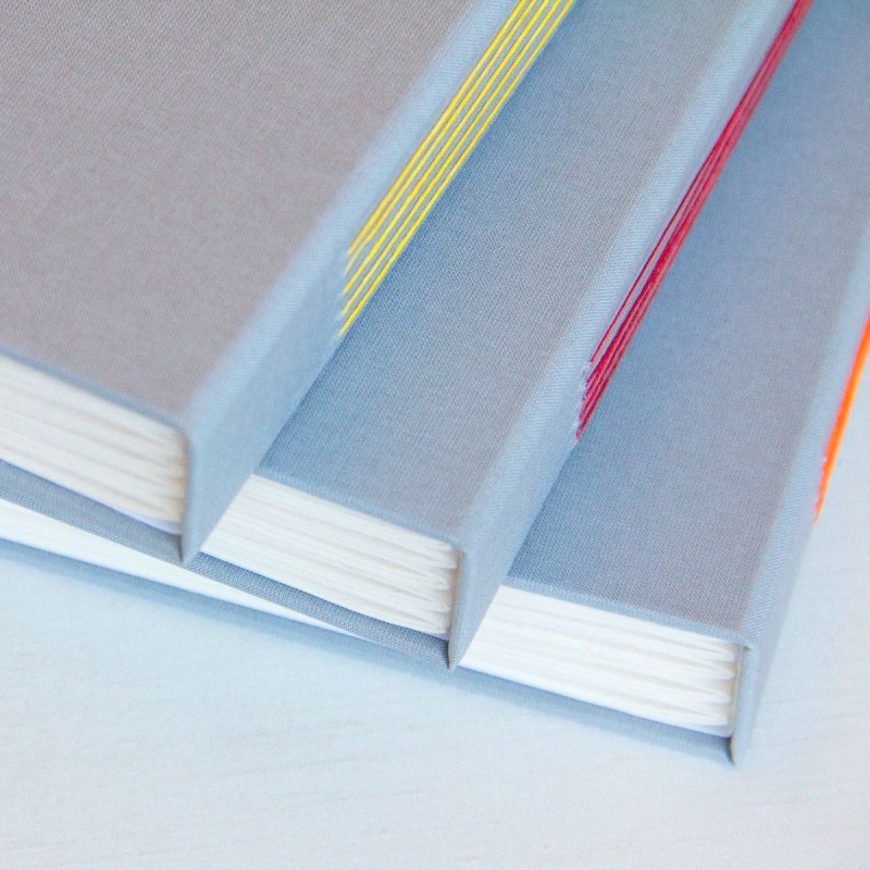 3 artist's books stacked on top of each other