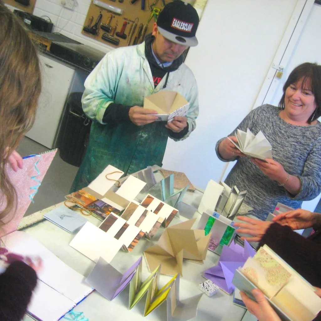 Bookbinding workshop participants looking at handmade books, Galway, Ireland