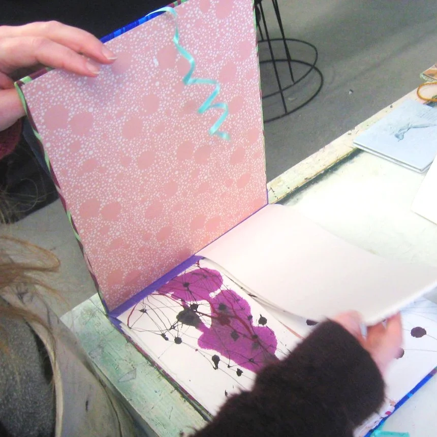Colourful artist's book with pink paint