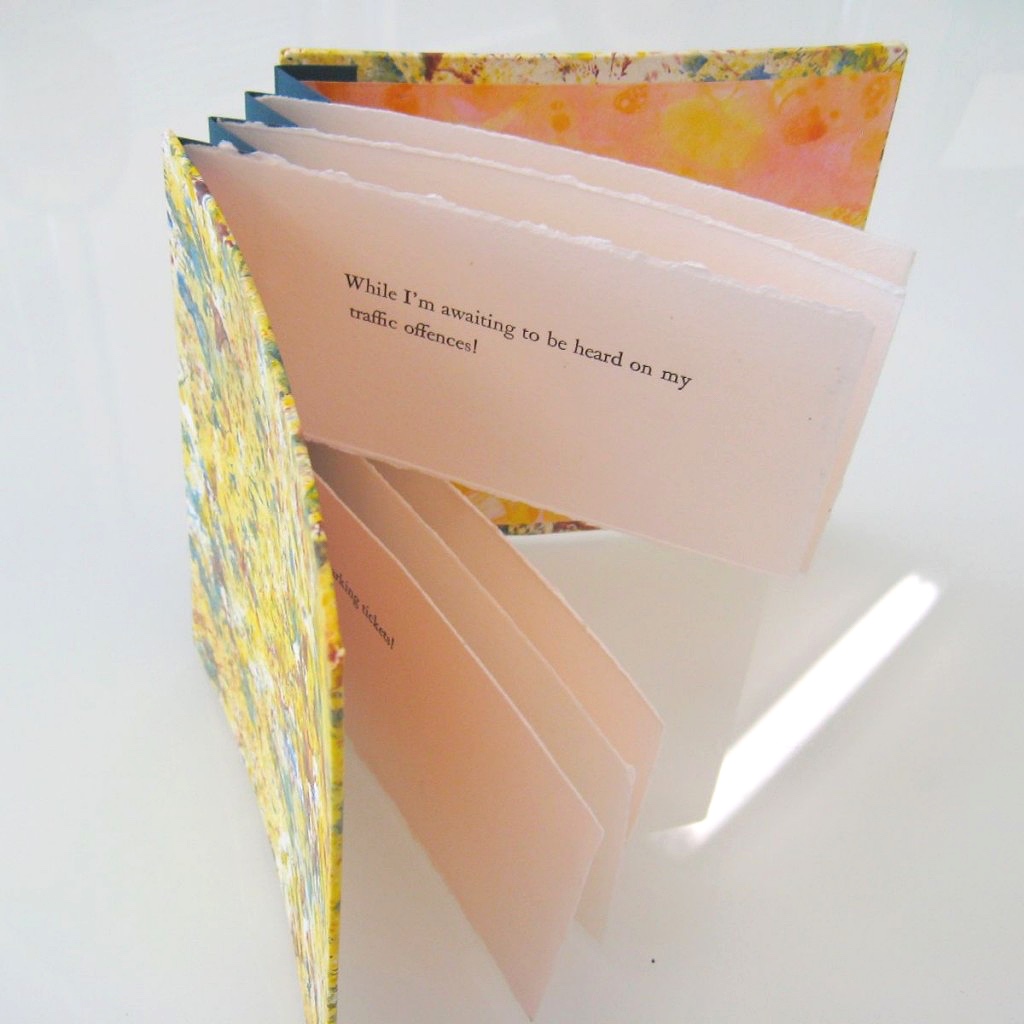 Handmade book with yellow cover and flag pages