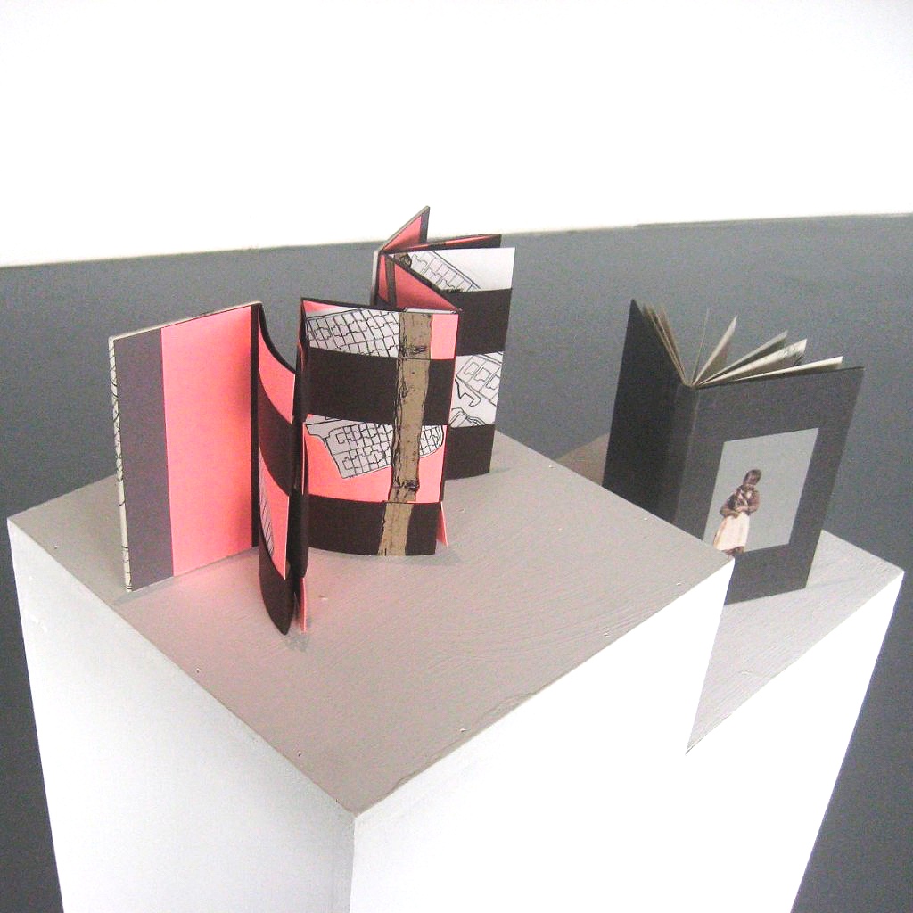 Two handmade artist's books on plinth