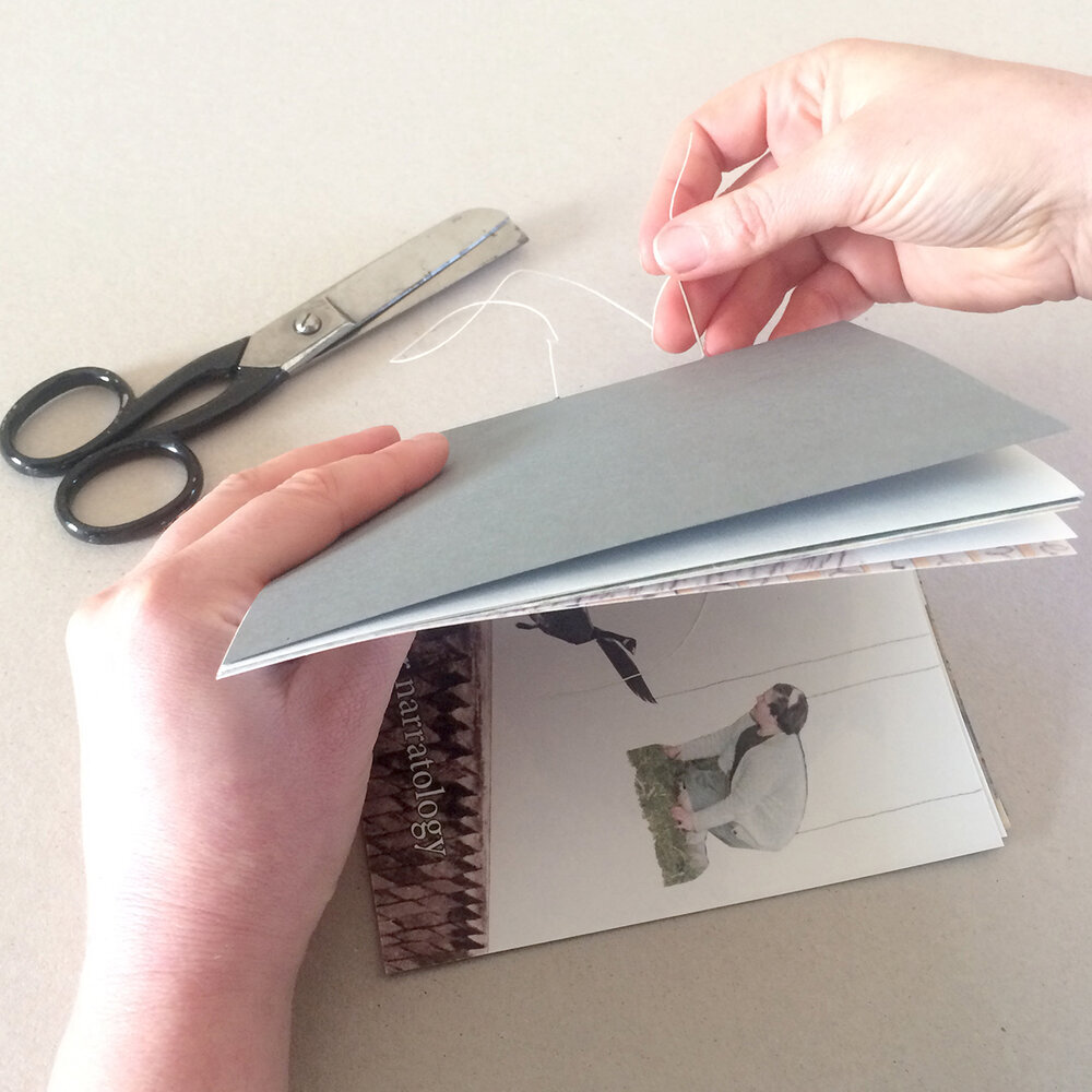 Eilis Murphy handbinding her artist's book with needle and white thread