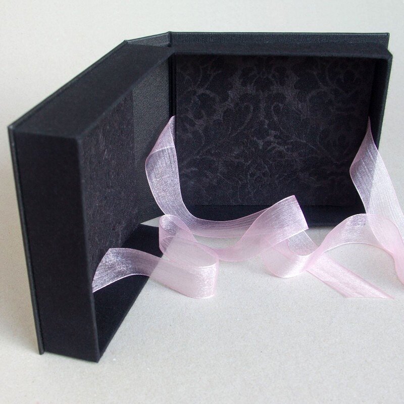 Black handmade box with sheer pink ribbon