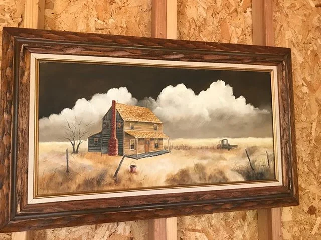 My dad bought this painting for his mother back in the 70s. It reminded him of the old homestead, the land her daddy drank away. This morning I put my face up close to decipher the name of the artist written in the right hand corner. And I swear I co