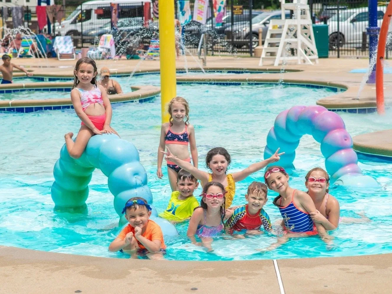 Children on play feature in pool with Life Floor pool tiles, pool safety surfacing, pool tiles, aqua tile