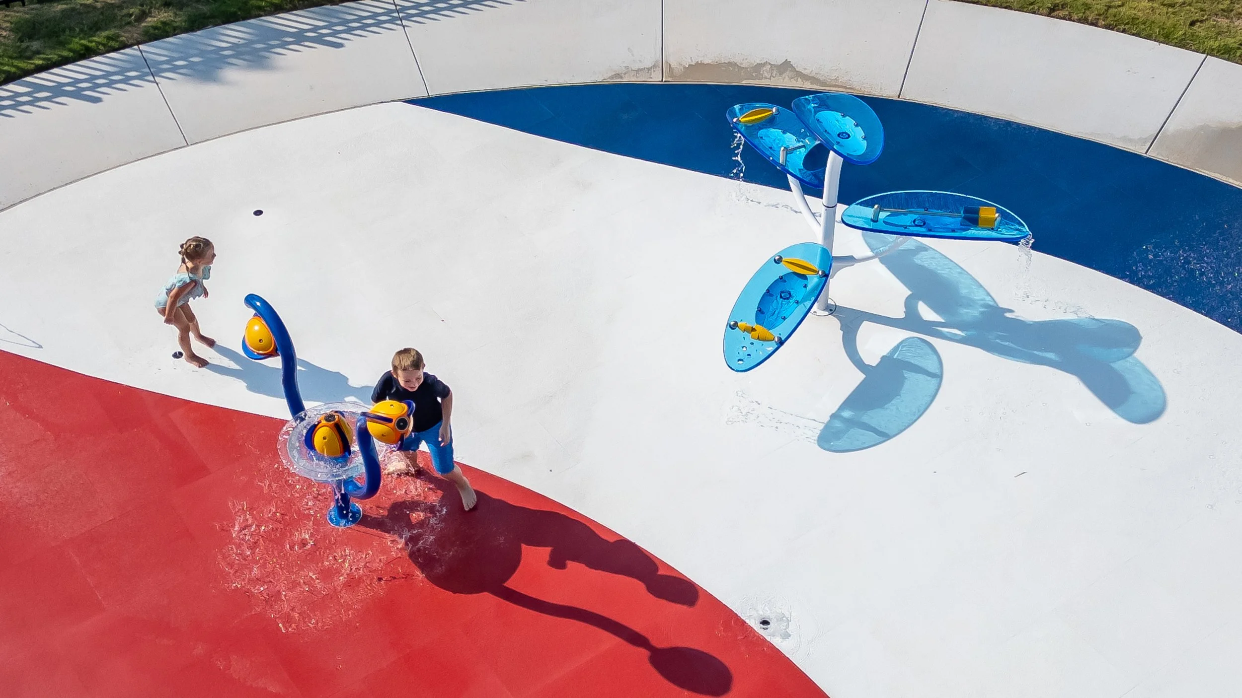 Wet Zone Waterpark's 3,000 sq ft splash pad features cushioned Life Floor tiles in Pomegranate, Submariner, and Porcelain. 