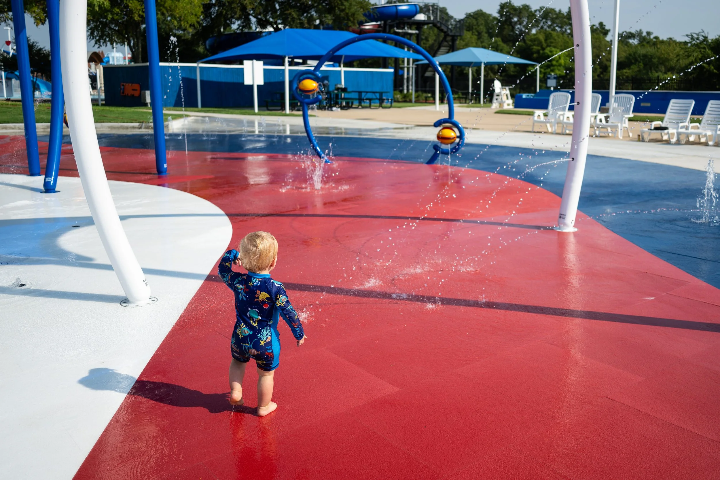 Families cool off on Wet Zone Waterpark's patriotic splash pad, surfaced with Life Floor aquatic safety tiles. 