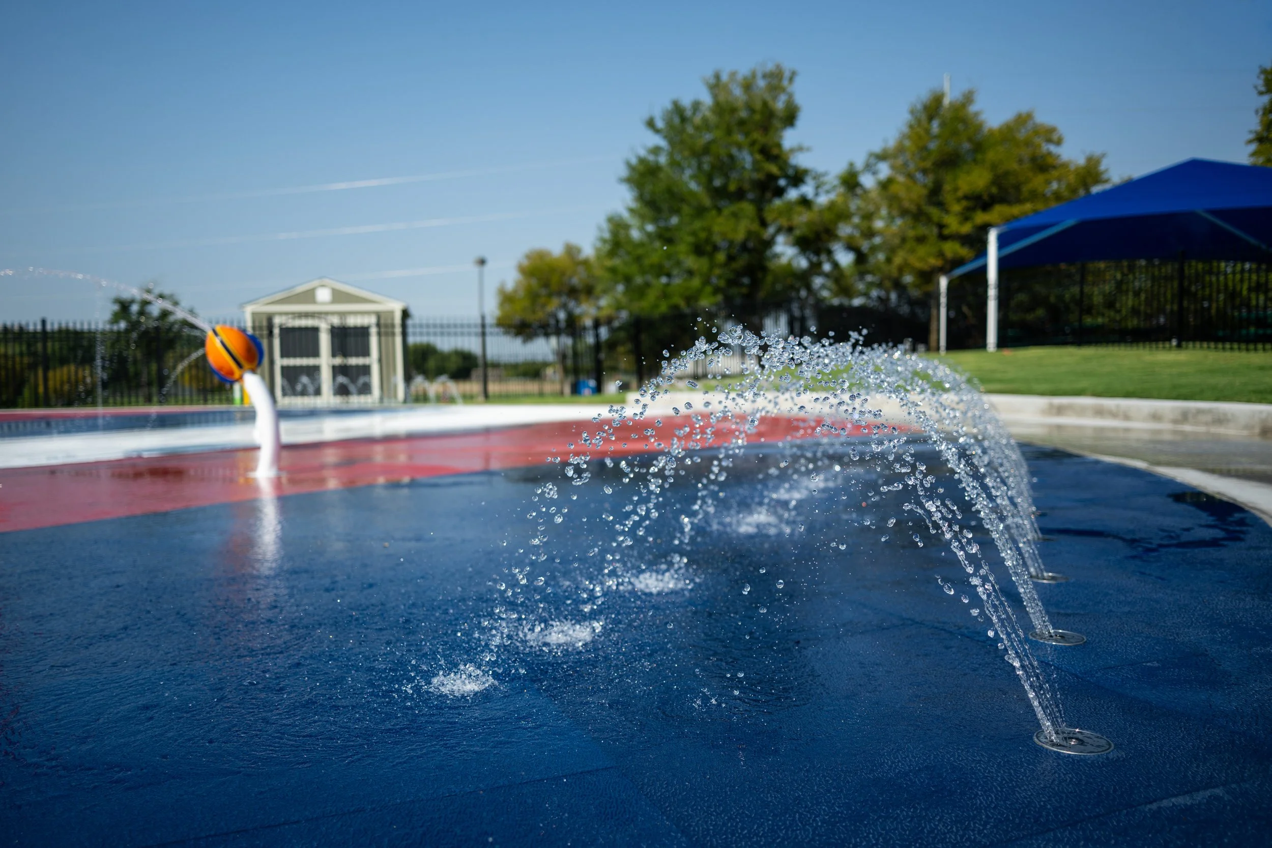Wet Zone Waterpark's 3,000 sq ft splash pad features cushioned Life Floor tiles in Pomegranate, Submariner, and Porcelain. 