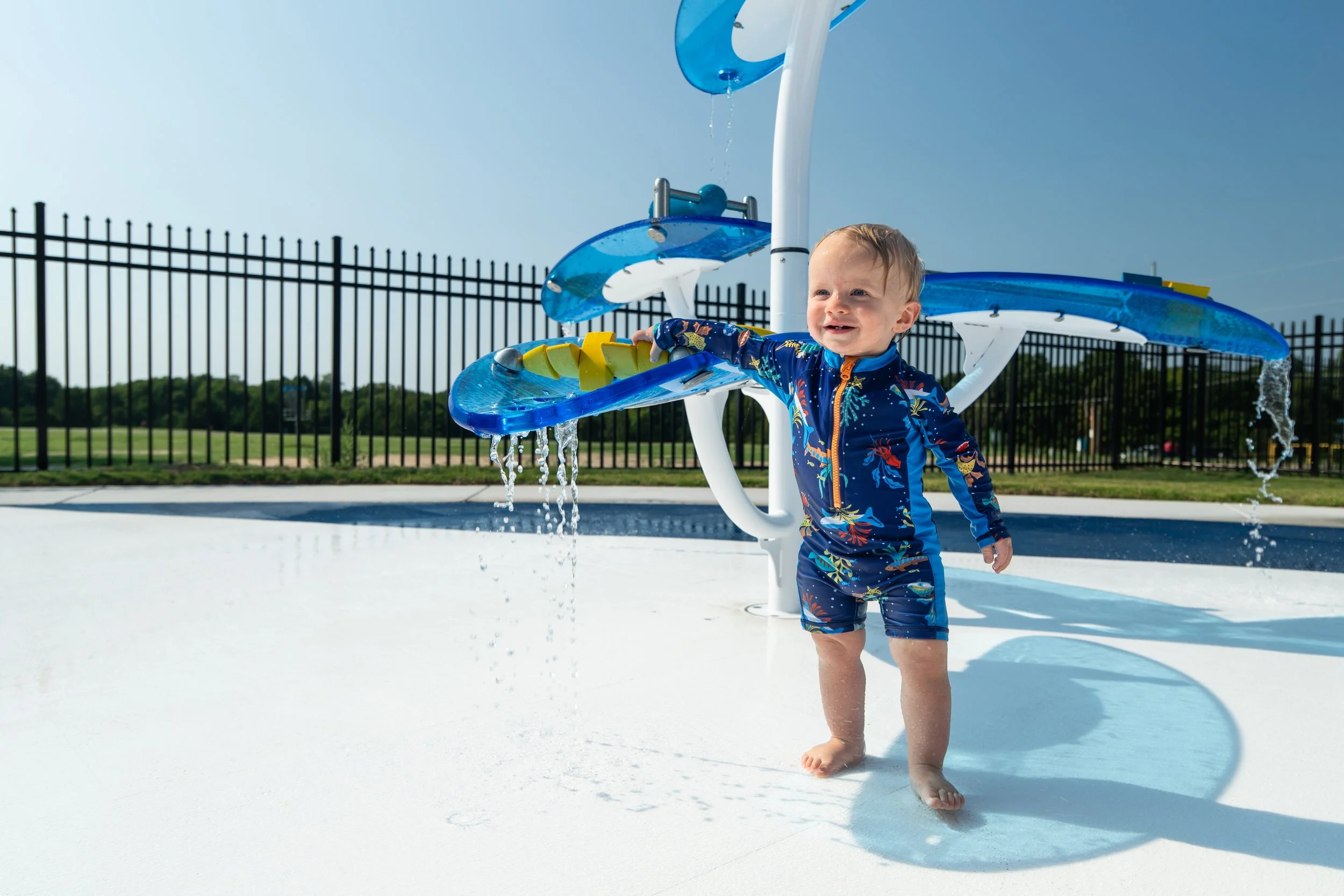 Families cool off on Wet Zone Waterpark's patriotic splash pad, surfaced with Life Floor aquatic safety tiles. 