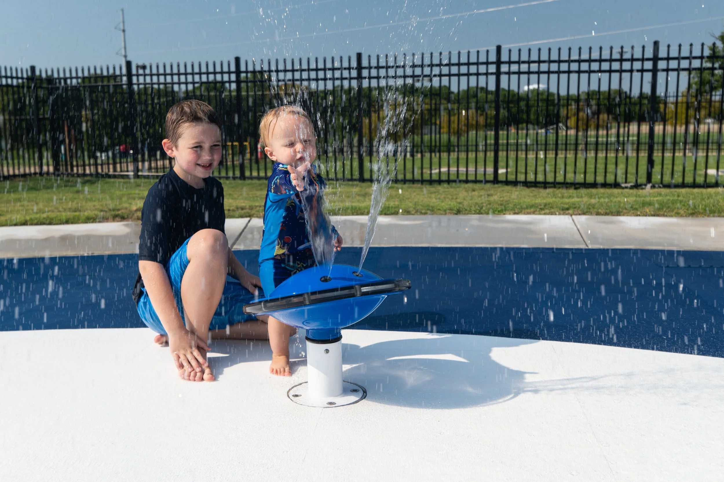 Bold red, white, and blue Life Floor design adds slip resistance and visual impact to Rowlett's community splash pad.