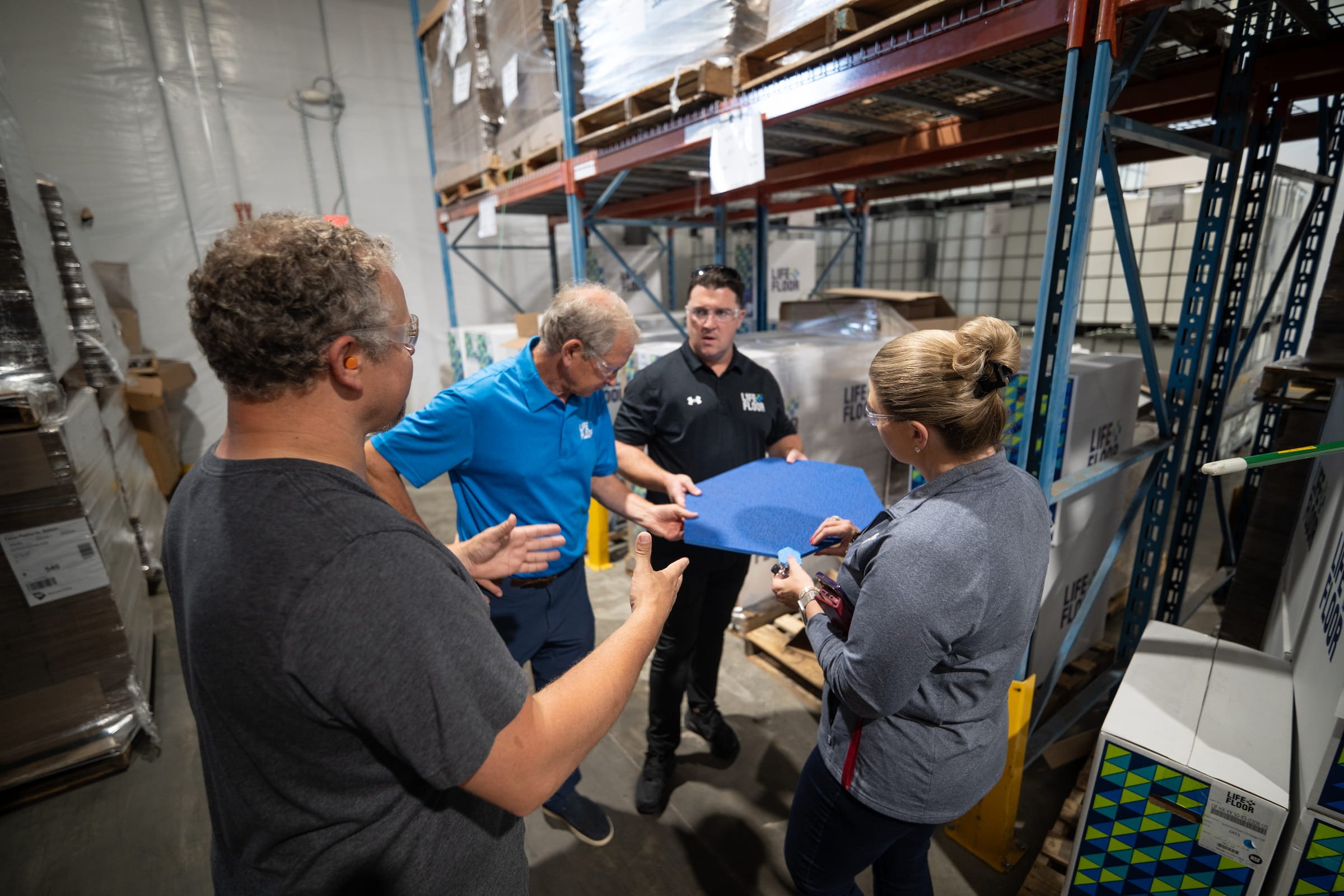 Life Floor team members looking at Hexagon Life Floor tile.