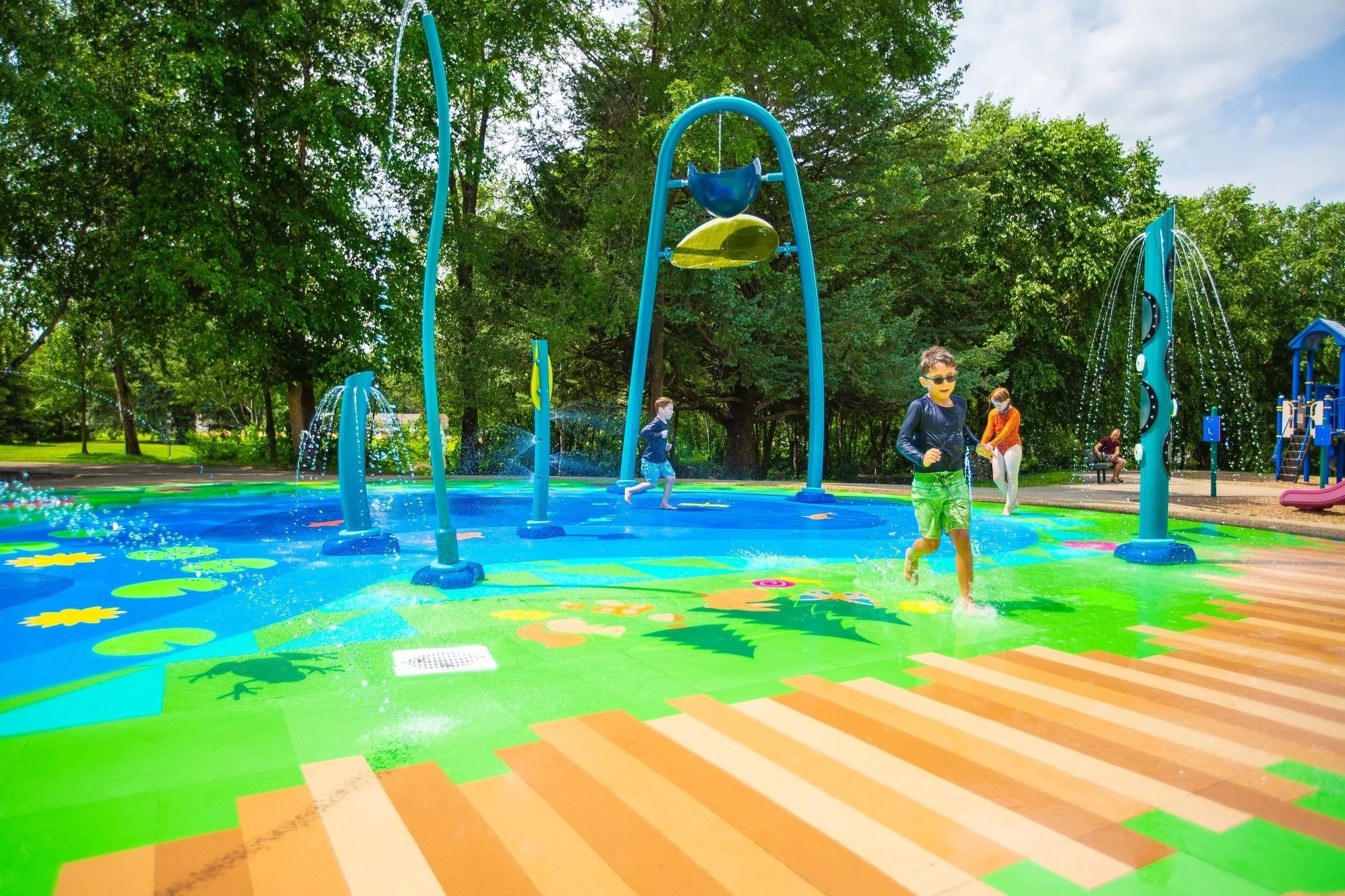 Children running and playing on splash pad with Life Floor splash pad surfacing