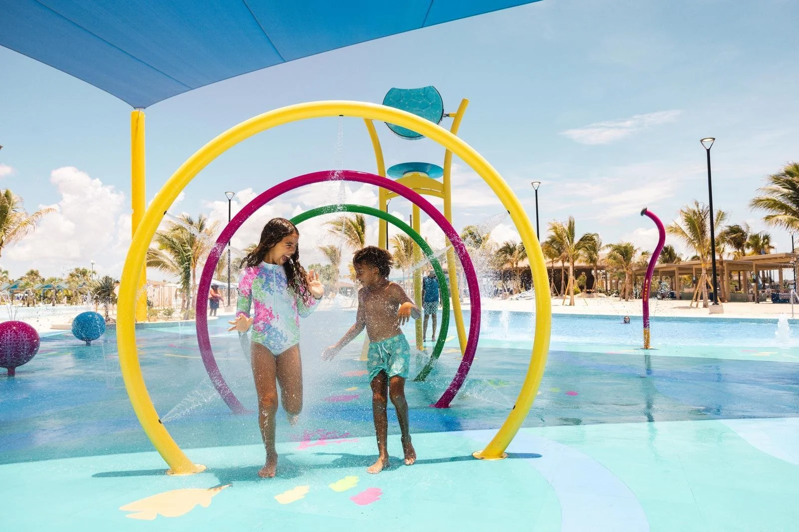 Children running across splash pad with NSF Certified Aquatic Safety Flooring, Life Floor Safety Flooring, Splash Pad Tiles