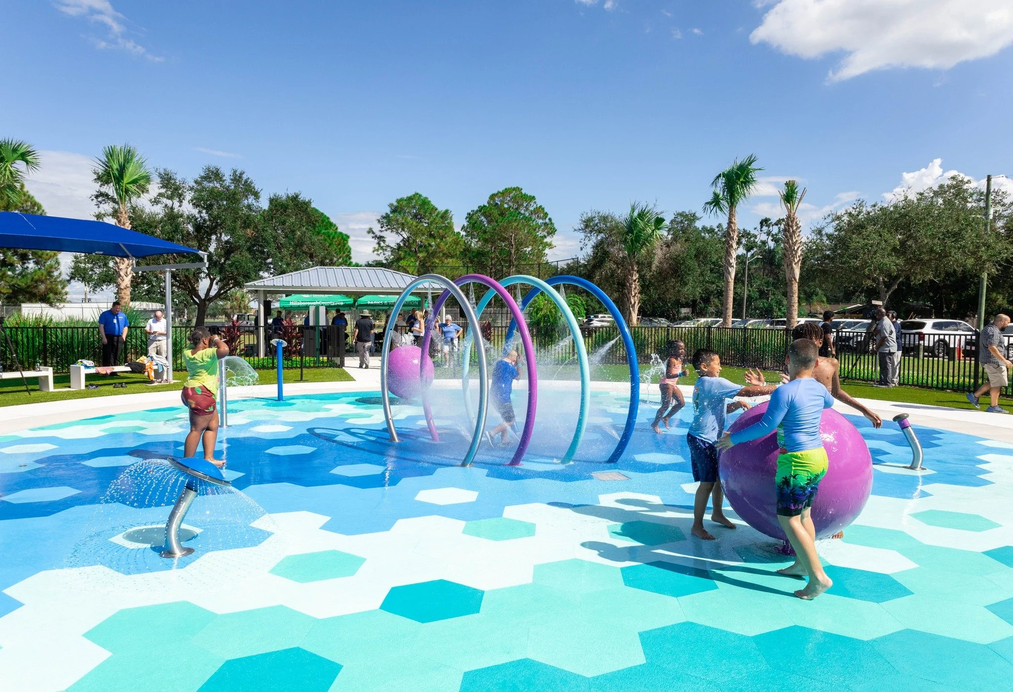 Children playing on colorful splash pad with Life Floor splash pad surfacing, splash pad ideas