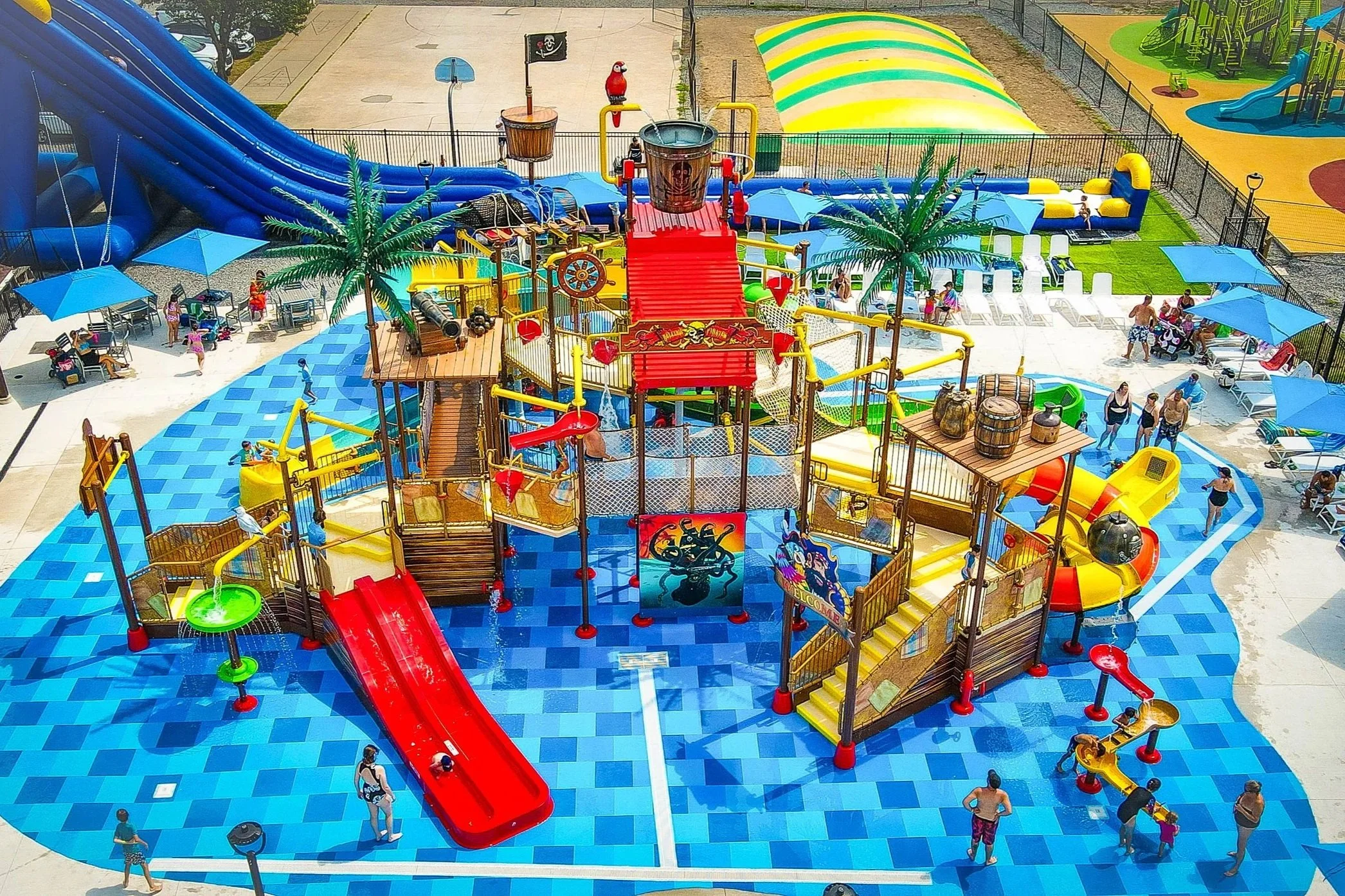 Jellystone Park Niagara Falls splash pad with guests playing on Life Floor splash pad flooring, water park theme ideas, splash pad surfacing, splash pad tiles