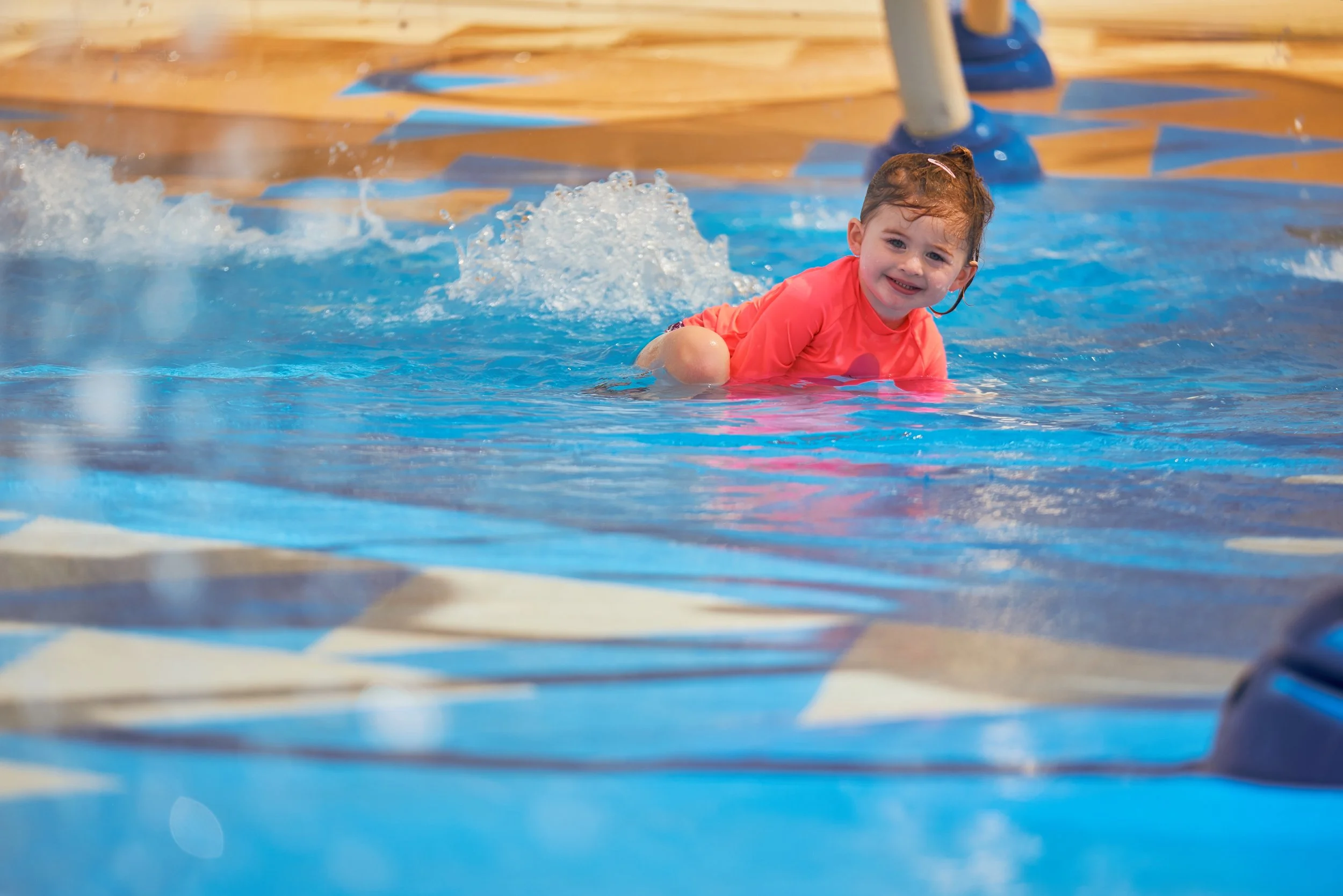Baby playing on splash pad with NSF-certified Life Floor Splash Pad Tiles, splash pad surface, splash pad safety surface