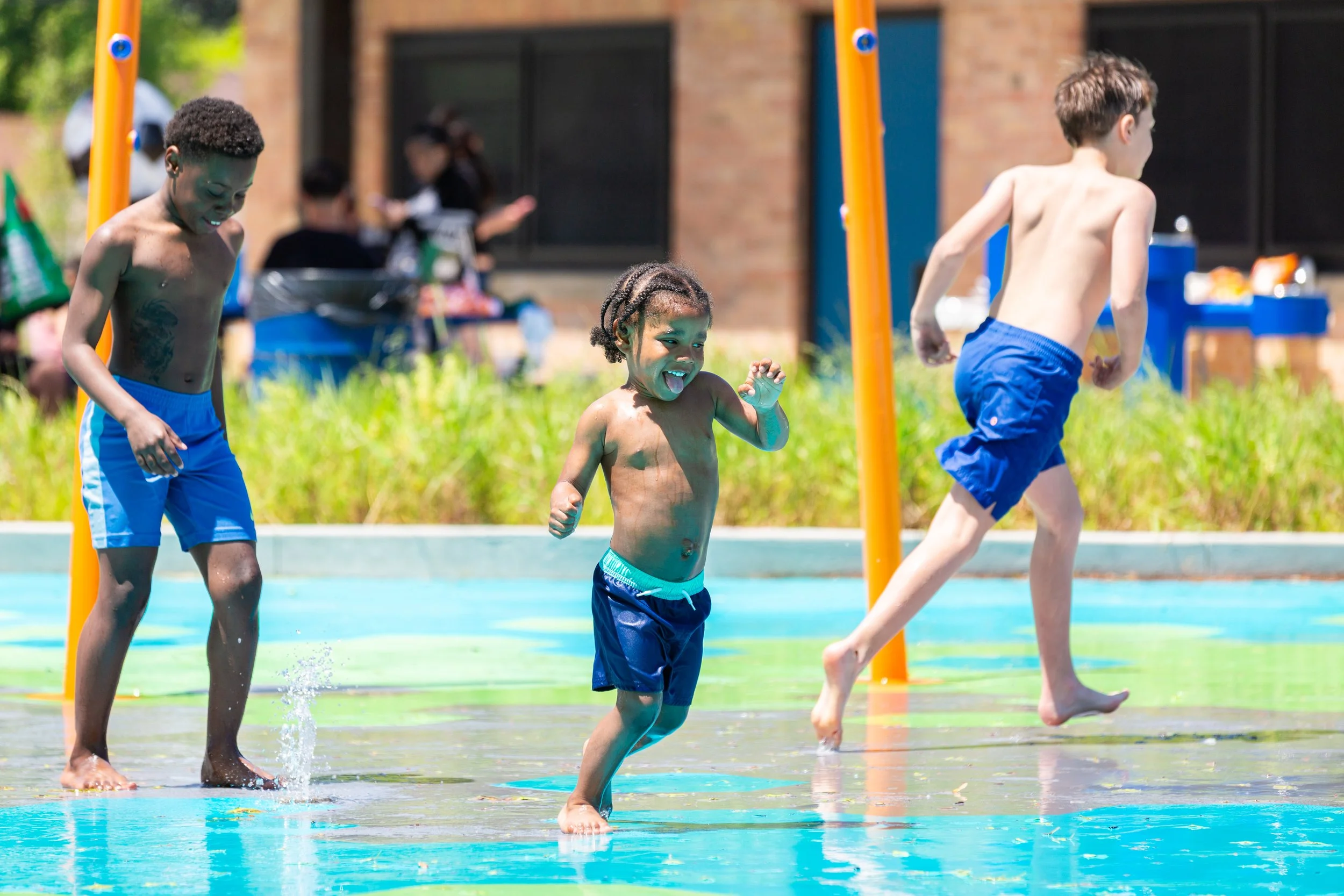 Children running on splash pad with Life Floor aquatic safety tiles, splash pad injury prevention, certified aquatic surfacing