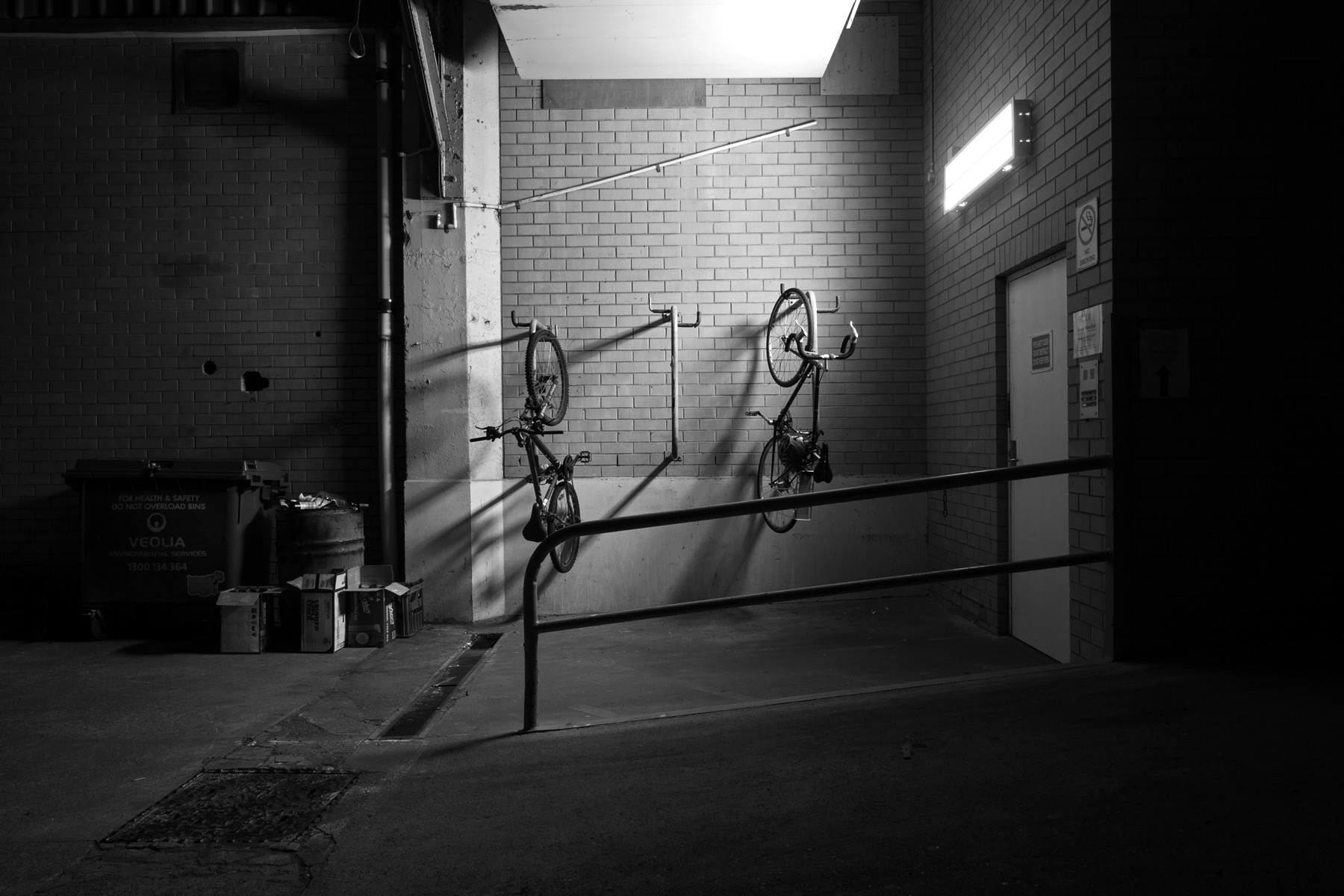 Bicycles hanging of a rack at night in West End, Brisbane