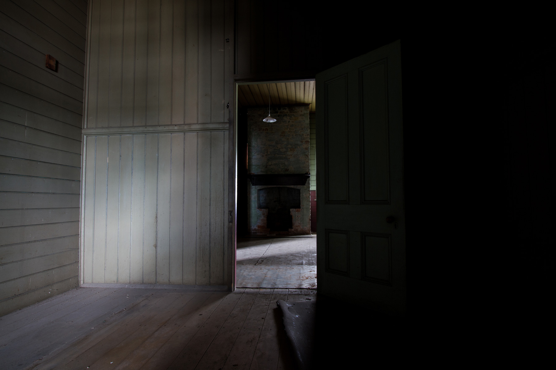 A fireplace through a doorway in an abandoned house in Bulimba, Brisbane