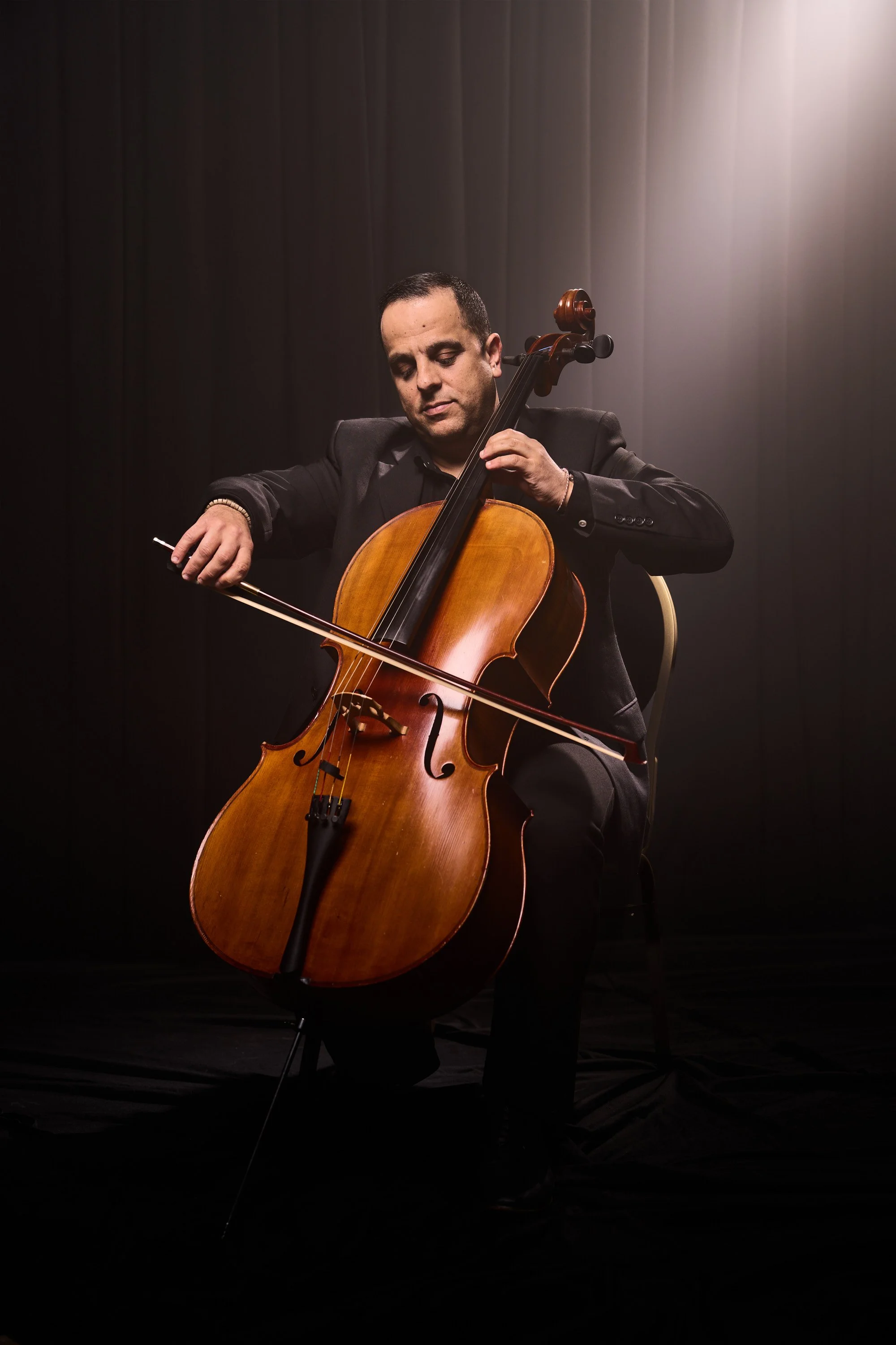 cellist-studio-portrait-in-spotlight-malta.jpg