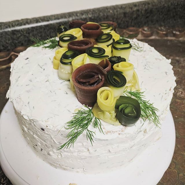 Savory smoked trout, wasabi mayo and truffle pate with dill cream cheese topped with purple carrots and zucchini rosetts.