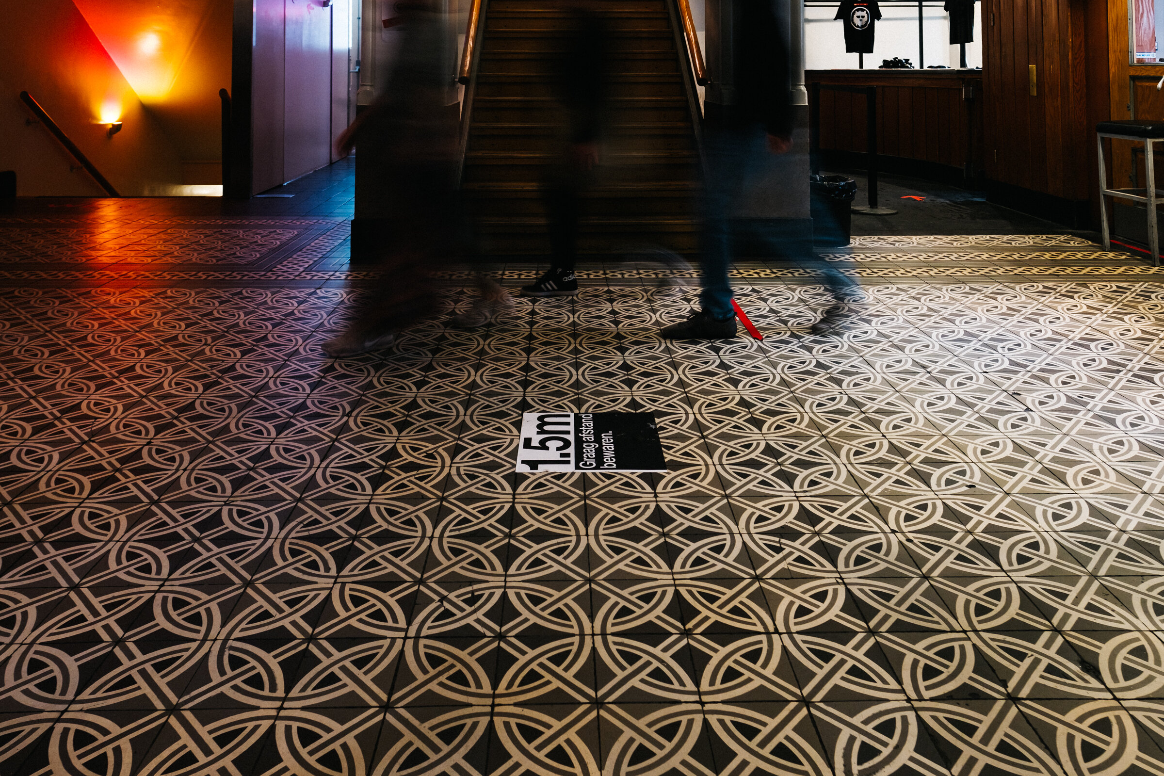  Visitors walk through Paradiso’s iconic main entrance, where stickers have been placed to remind them of the required 1.5-metre distance at Paradiso, Amsterdam, August 28, 2020.  