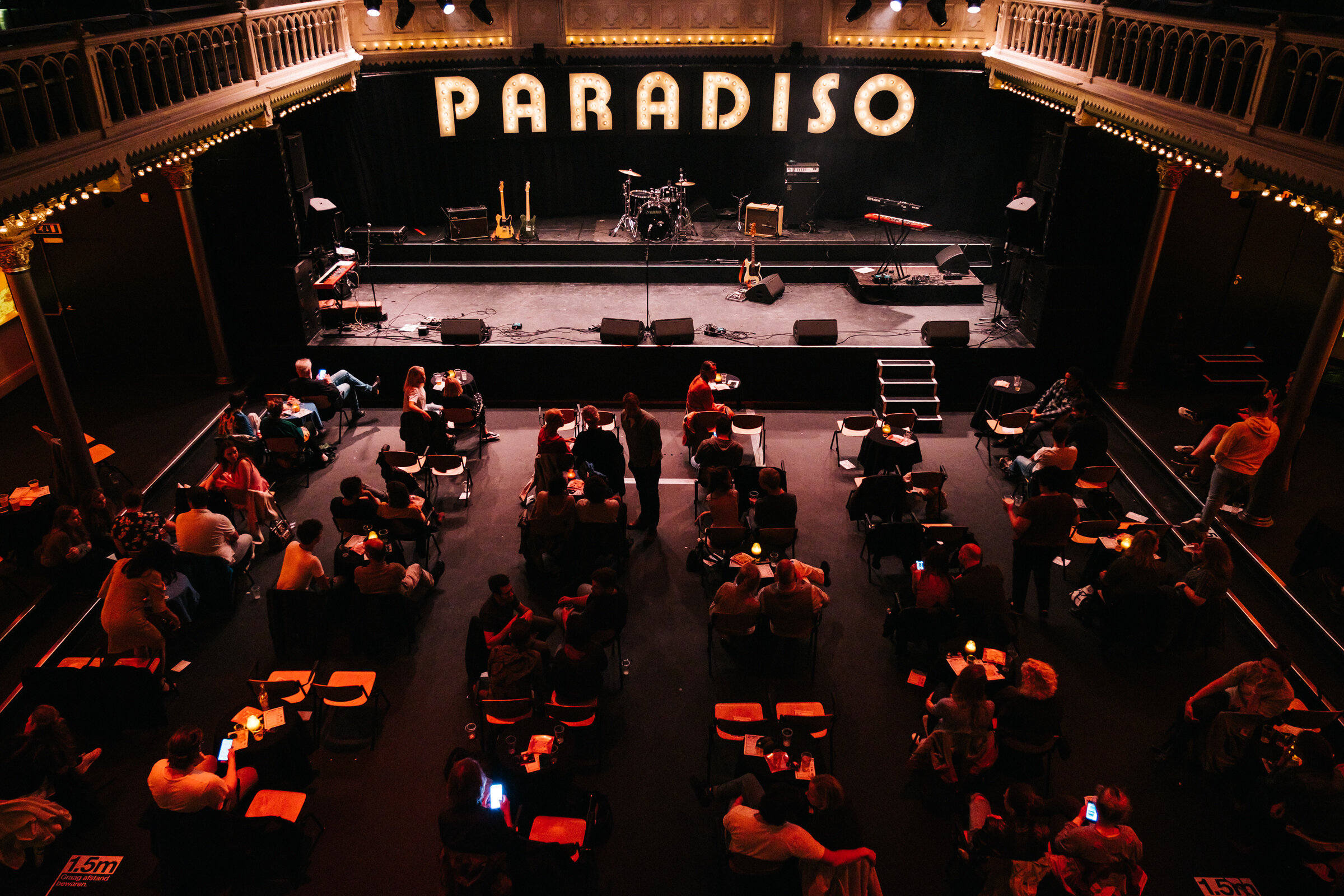  Visitors wait between shows in the main hall during Cafe Paradiso 15 Jaar at Paradiso, August 25, 2020. Cafe Paradiso is held annually and during the evening, several bands play for half an hour. 