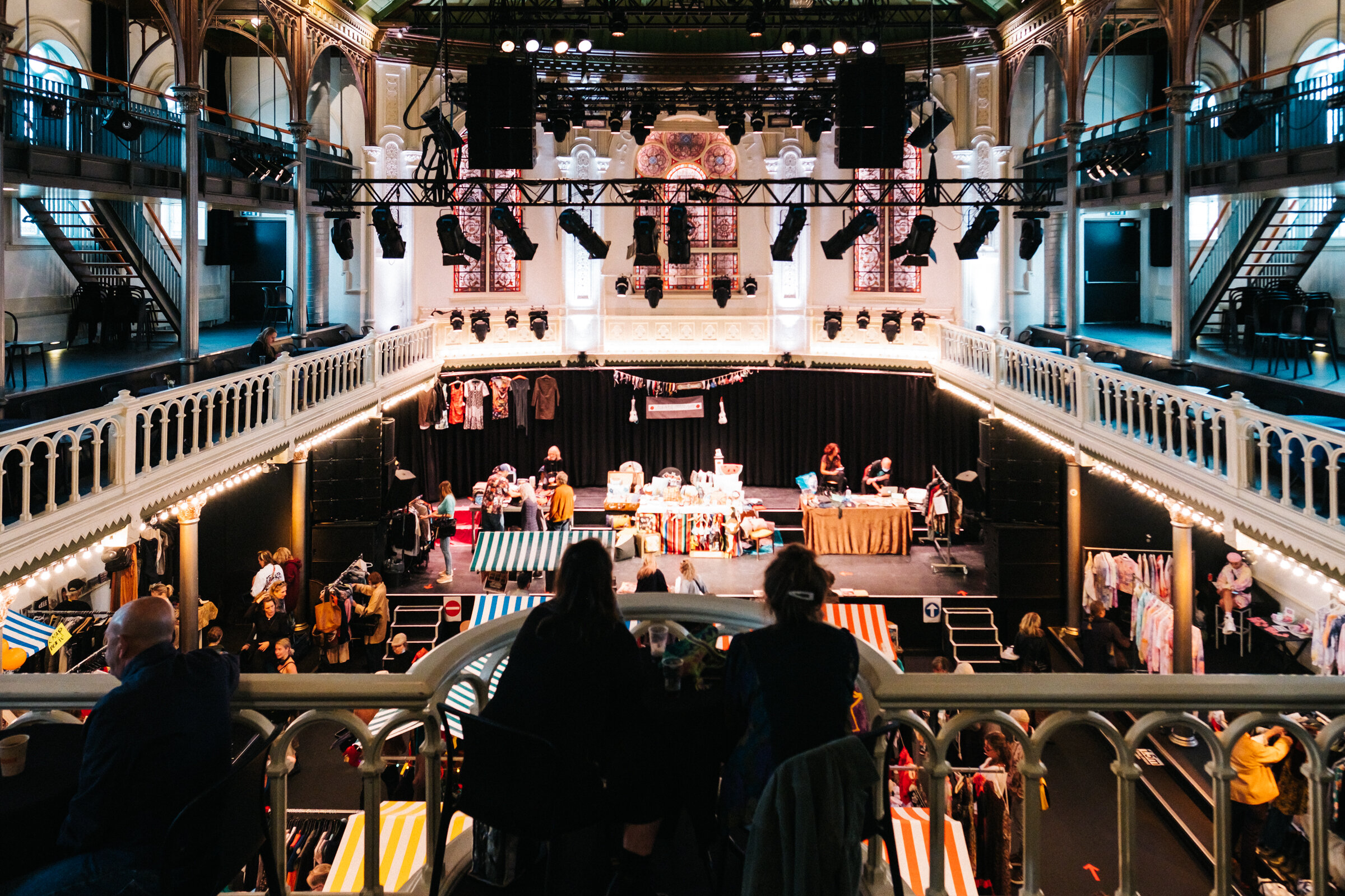  From the first balcony, visitors overlook the main hall and the pop-up market during Parafanalia at Paradiso, Amsterdam, August 30, 2020. Parafanalia is a bring &amp; buy jumble sale that attracts all sorts of visitors. 