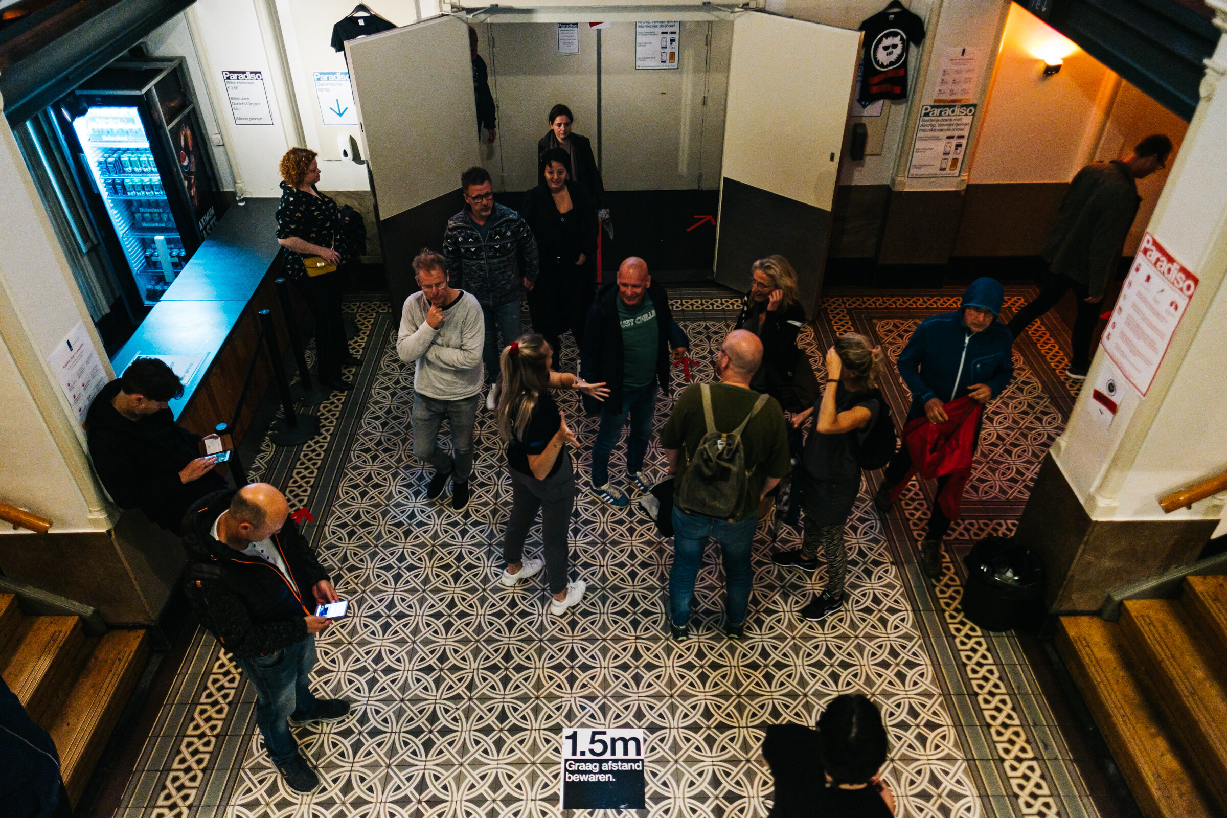  A Paradiso staff member asks a group of visitors lingering in the main hall to move outside after a sold-out Claw Boys Claw concert at Paradiso, Amsterdam, August 28, 2020. Despite staff trying to control the flow of exiting people by sending them o