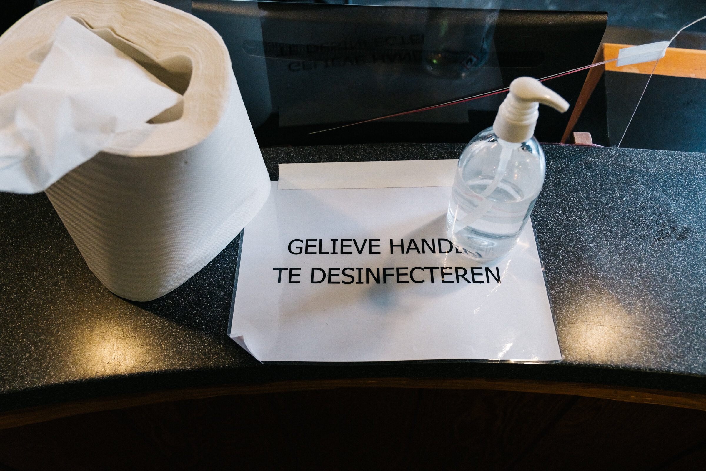  A sign saying ‘PLEASE DISINFECT YOUR HANDS’ at the reception desk at Paradiso, Amsterdam, September 6, 2020. Similar signs and disinfection points are spread out throughout Paradiso.  