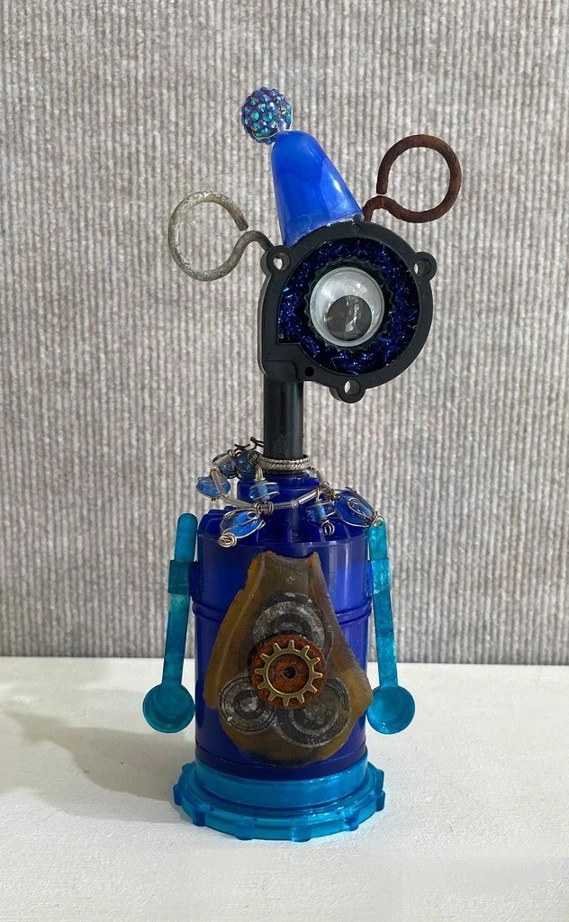Linda Gooch “The Little Blue Man” Water pump housing, filter, rusted scissors, and more