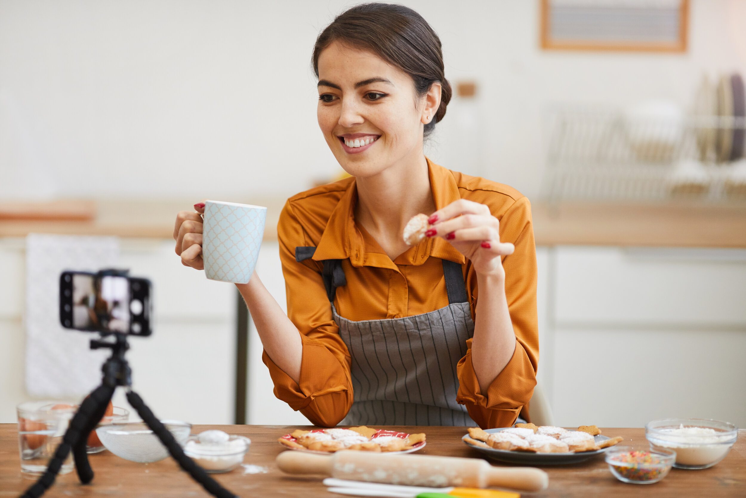 young-woman-filming-in-cozy-kitchen-N6XFQPK.jpg