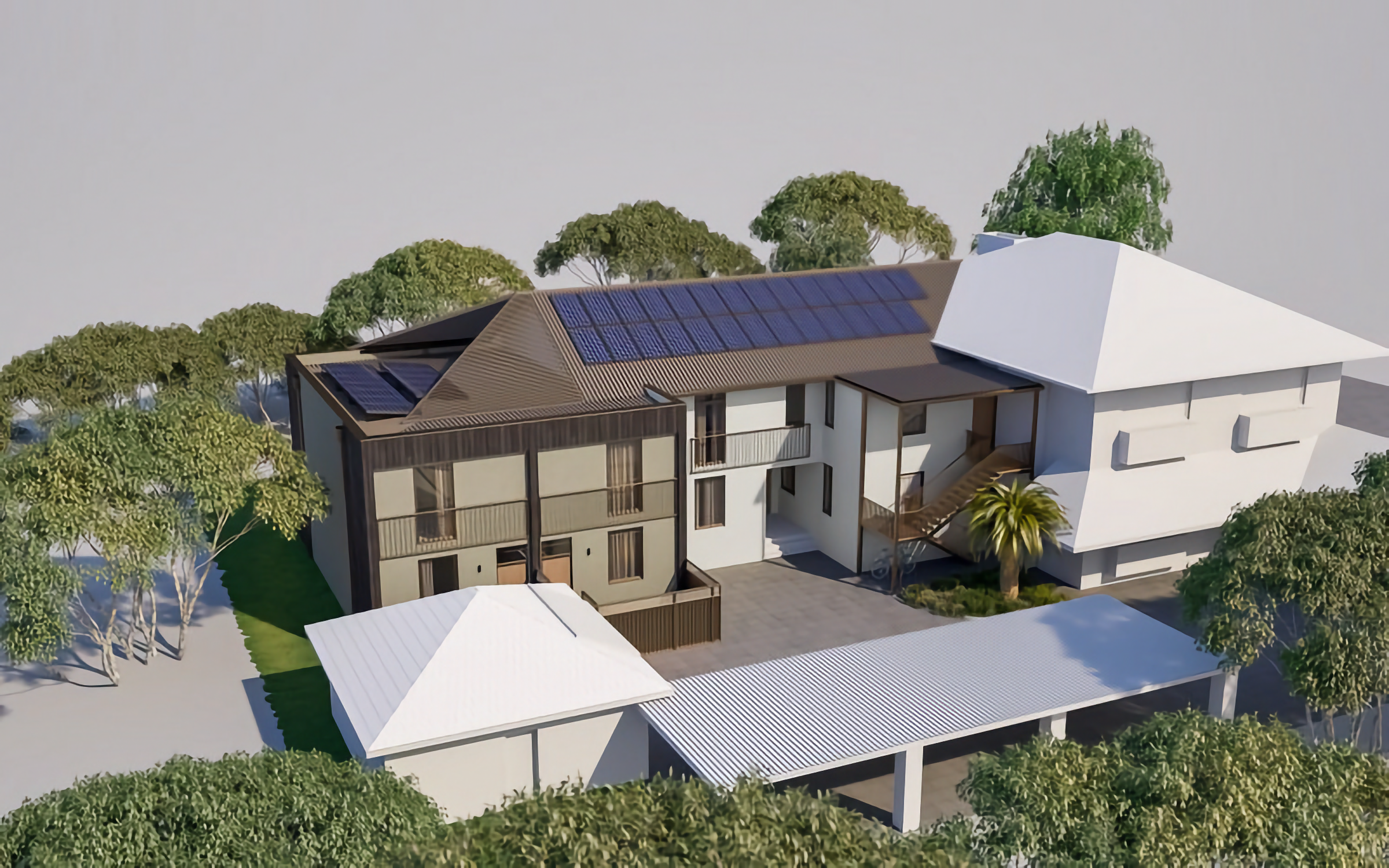 A modern house with solar panels on the roof, surrounded by trees and greenery, featuring a patio area and an extended carport.