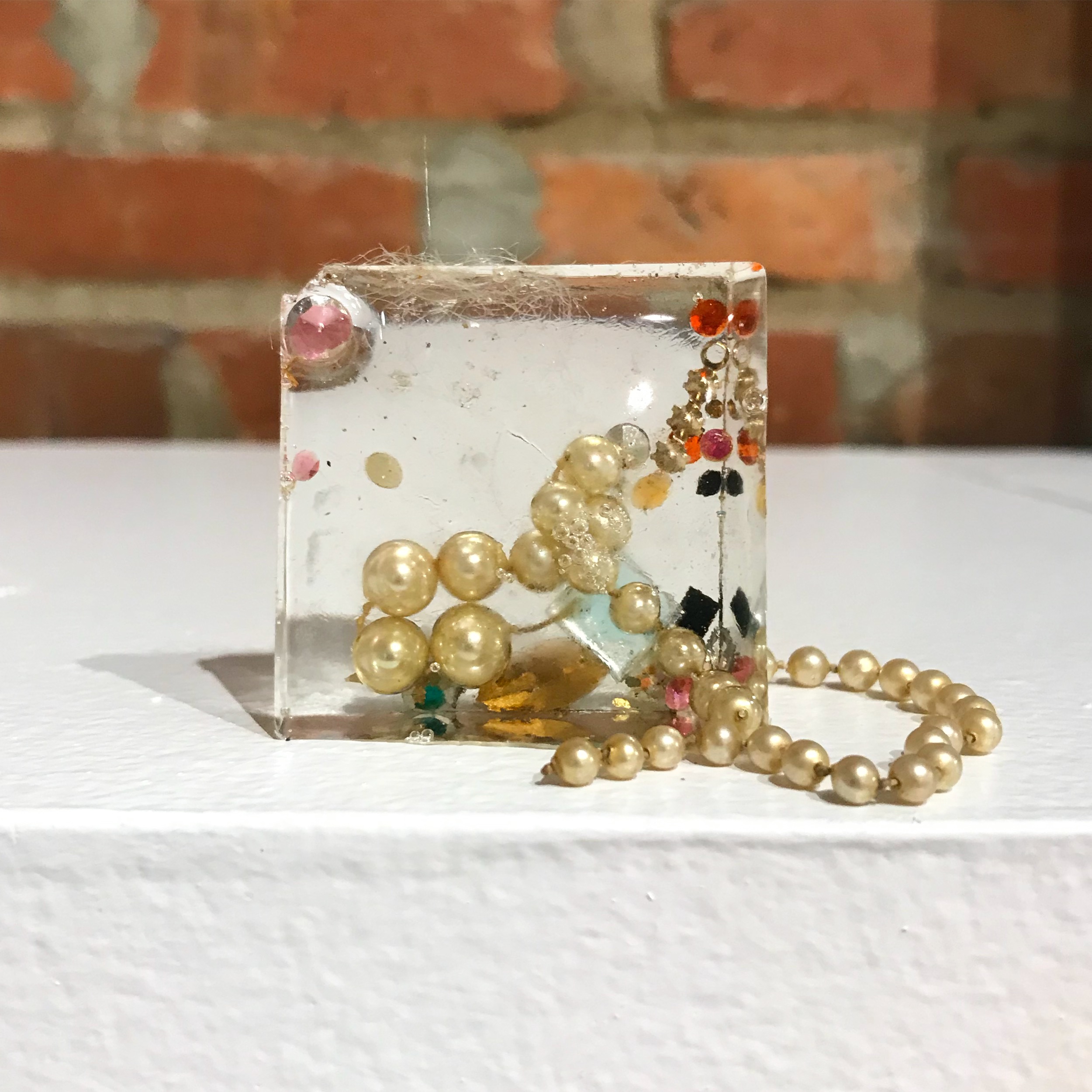  Sugar Cube, 2019, faux pearls, rhinestones, and beads cast in resin, 2x2” 